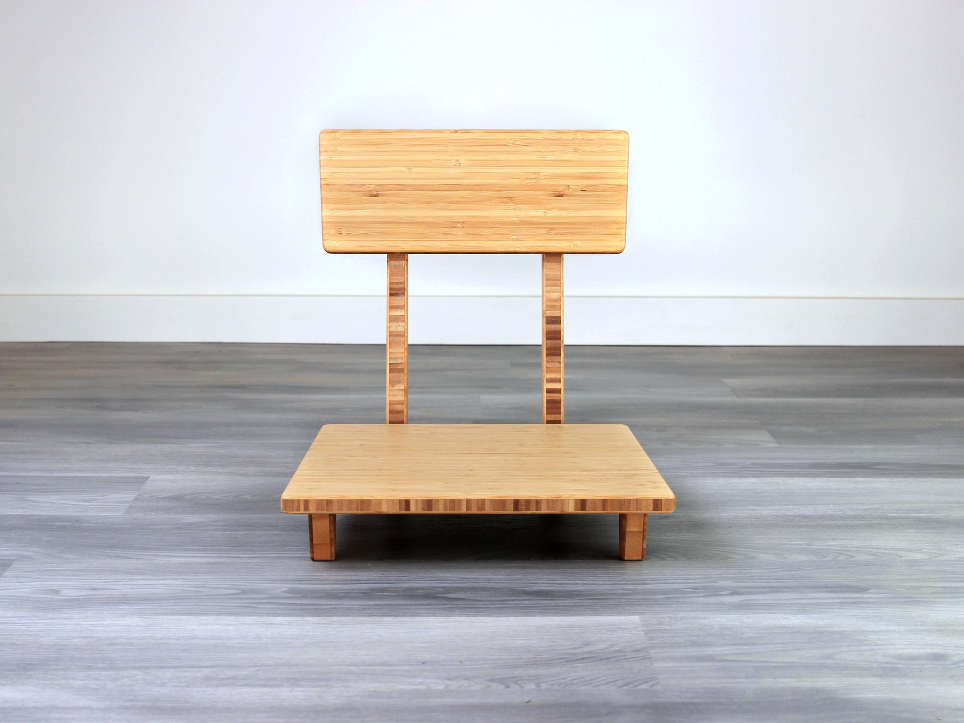 Sustainable bamboo floor chair featuring a low-profile design and sturdy backrest, perfect for meditation and Japanese-style low tables. Placed on grey floor and white back wall.
floor chair
chabudai
contemporary
low seating 
floor chair with back 
ergonomic