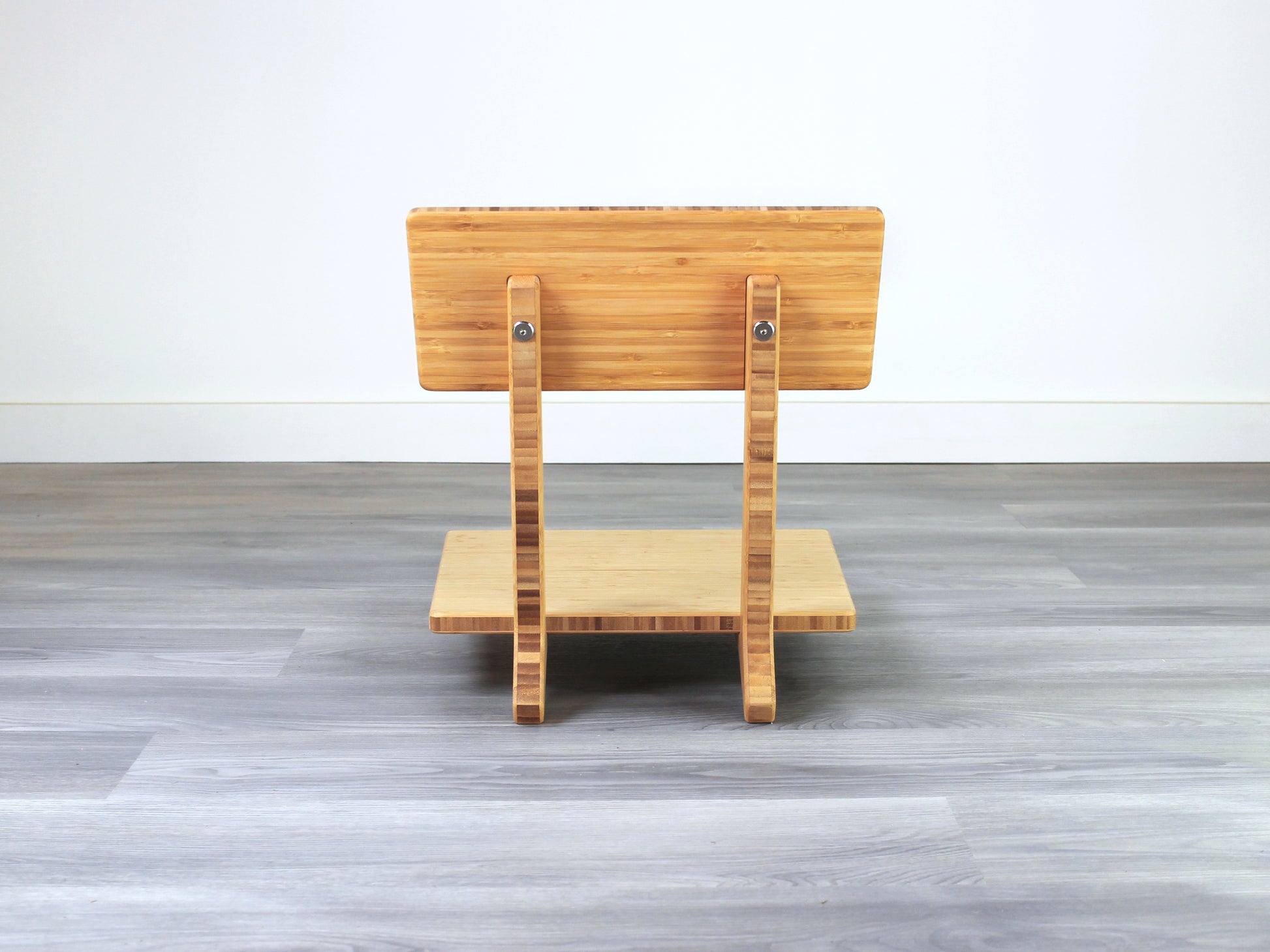 Sustainable bamboo floor chair featuring a low-profile design and sturdy backrest, perfect for meditation and Japanese-style low tables. Placed on grey floor and white back wall.
floor chair
chabudai
contemporary
low seating 
floor chair with back 
ergonomic