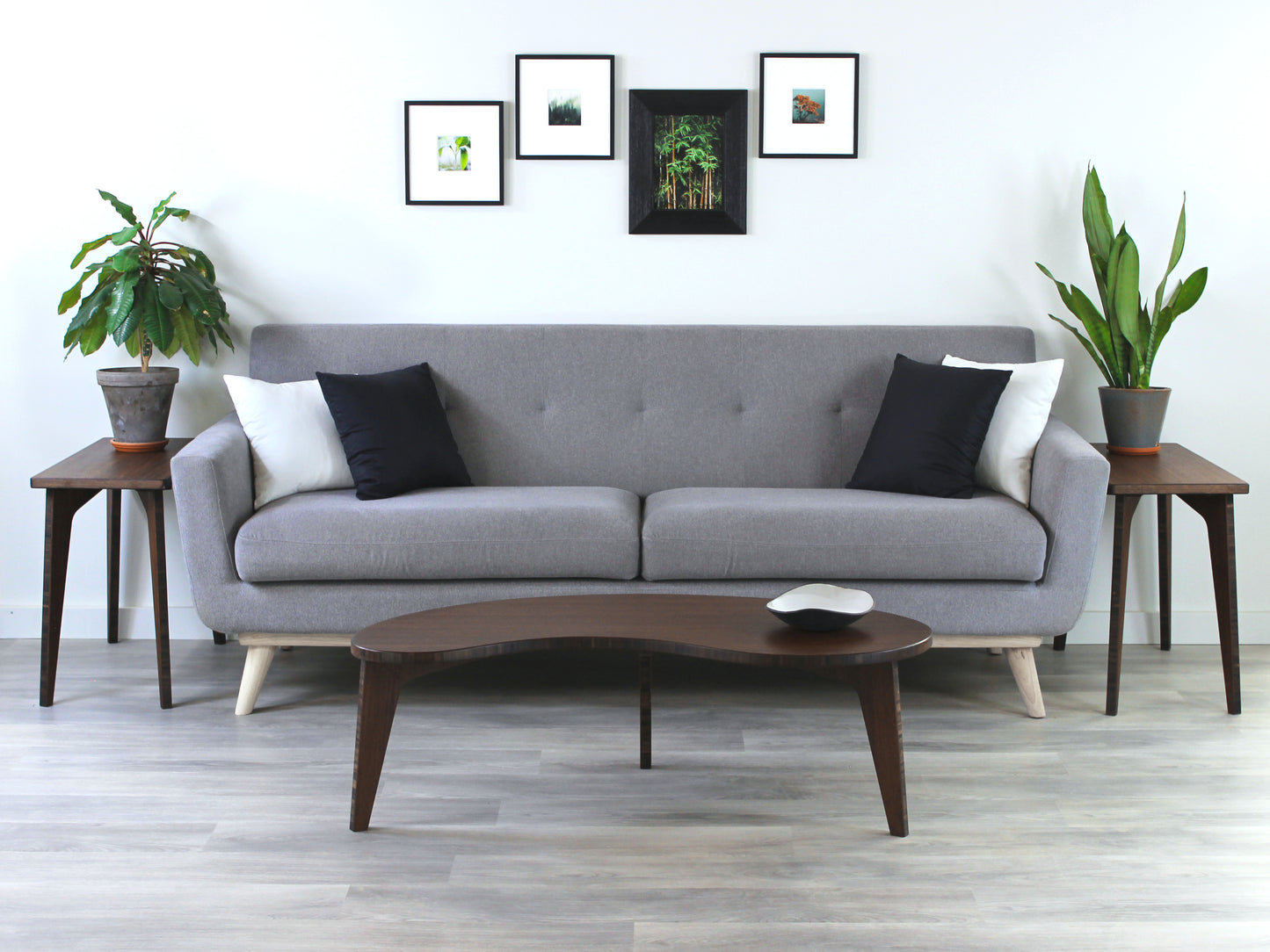 Kidney table in bamboo with a walnut finish, featuring a Japandi style design, set on a grey floor with a white background. Set in a living room area, a grey couch and side tables with houseplants. A small black pottery vessel is placed on the table top.
mid century modern low table
midcentury modern coffee table
floor table
japan coffee table
japan furniture
japan table
kidney coffee table
bamboo low table