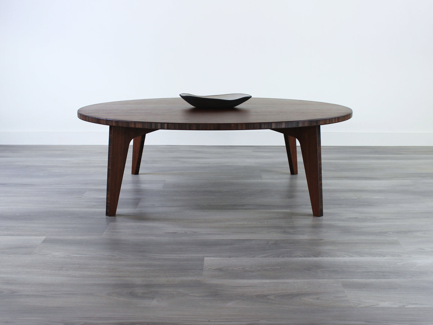 A round, walnut-colored bamboo table with a flat surface and curved legs on a gray floor, accompanied by a single black bowl.
Square low table
japanese furniture
japanese low table
low coffee table
low dining table
low table
mid century
minimalist
minimalist table
modern
chabudai
kotatsu
large coffee table