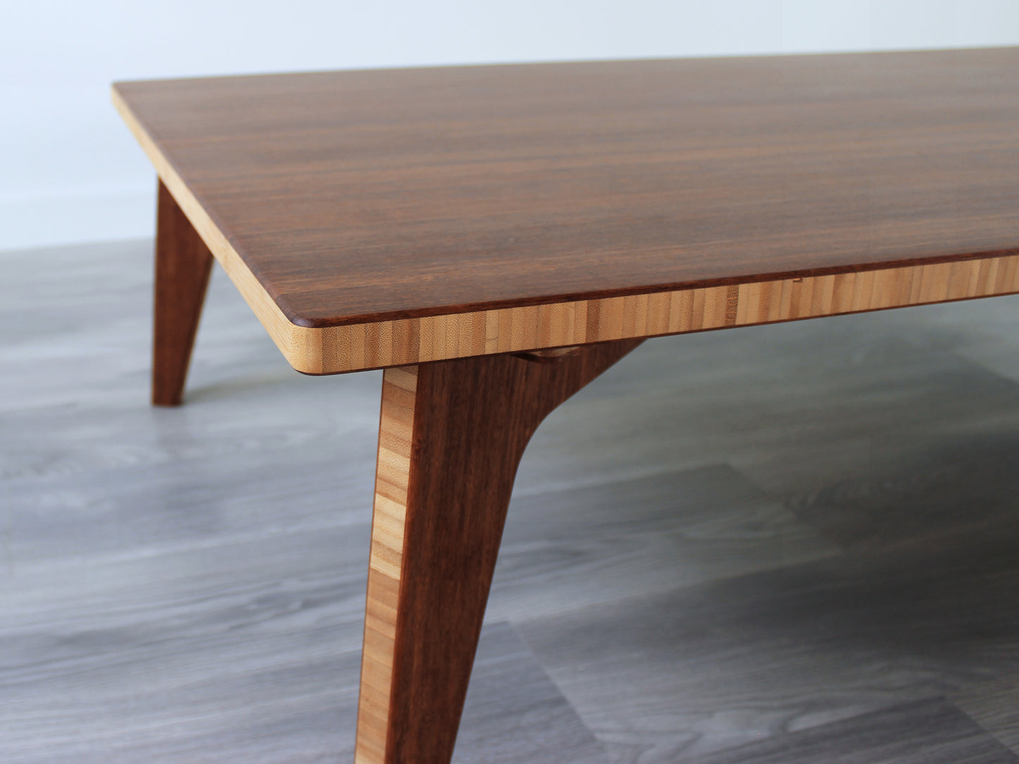 A large rectangular low table made of bamboo with a chestnut finish, placed on a grey floor with a white background.
japanese furniture
japanese low table
low coffee table
low dining table
low table
mid century
minimalist
minimalist table
modern
chestnut grain