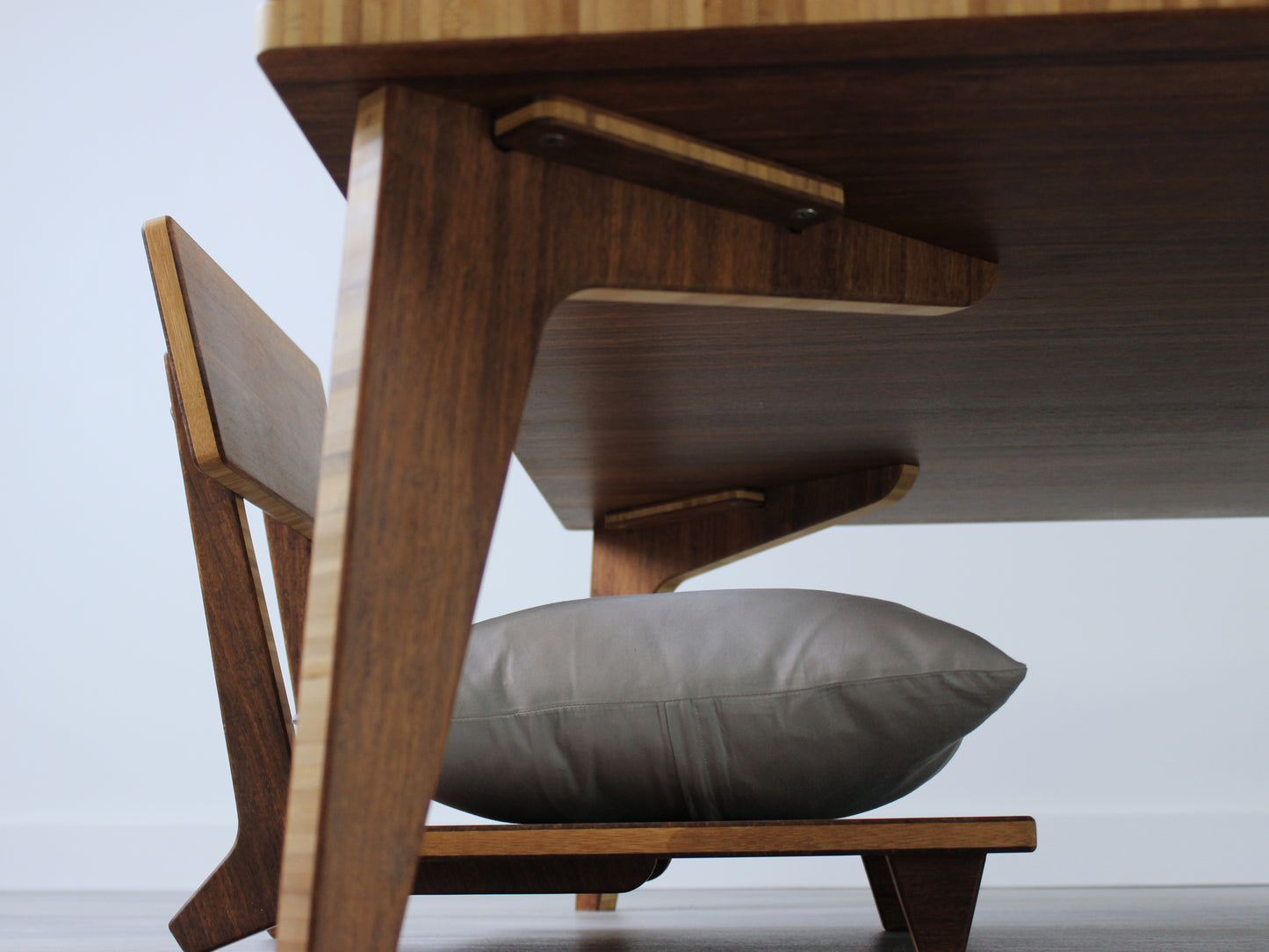 Large square floor table in bamboo with a chestnut color finish, featuring a Japandi style design, set on a grey floor with a white background. A Floor Chair Comfort with a grey pillow is set underneath. Underside view featuring the removable legs and hardware.
Square low table
japanese furniture
japanese low table
low coffee table
low dining table
low table
mid century
minimalist
minimalist table
modern
chabudai