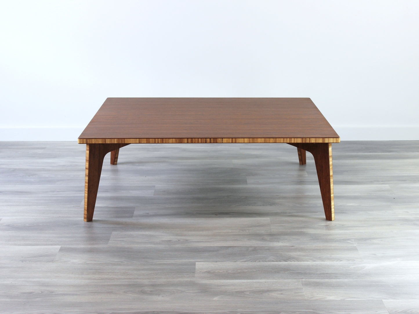Large square floor table in bamboo with a chestnut color finish, featuring a Japandi style design, set on a grey floor with a white background.
Square low table
japanese furniture
japanese low table
low coffee table
low dining table
low table
mid century
minimalist
minimalist table
modern
chabudai