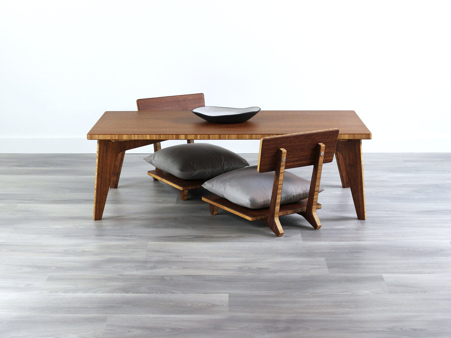 Small Rectangle Table Set - Chestnut, low table with Floor Chair Comfort set under with grey pillow. Set on a grey floor, against a white background. A small black pottery vessel is on the table top.
low table, coffee table, dining table, floor desk, floor chair, floor seating, low dining table, chabudai, tatami, kotatsu, minimalist, minimalist table,
modern