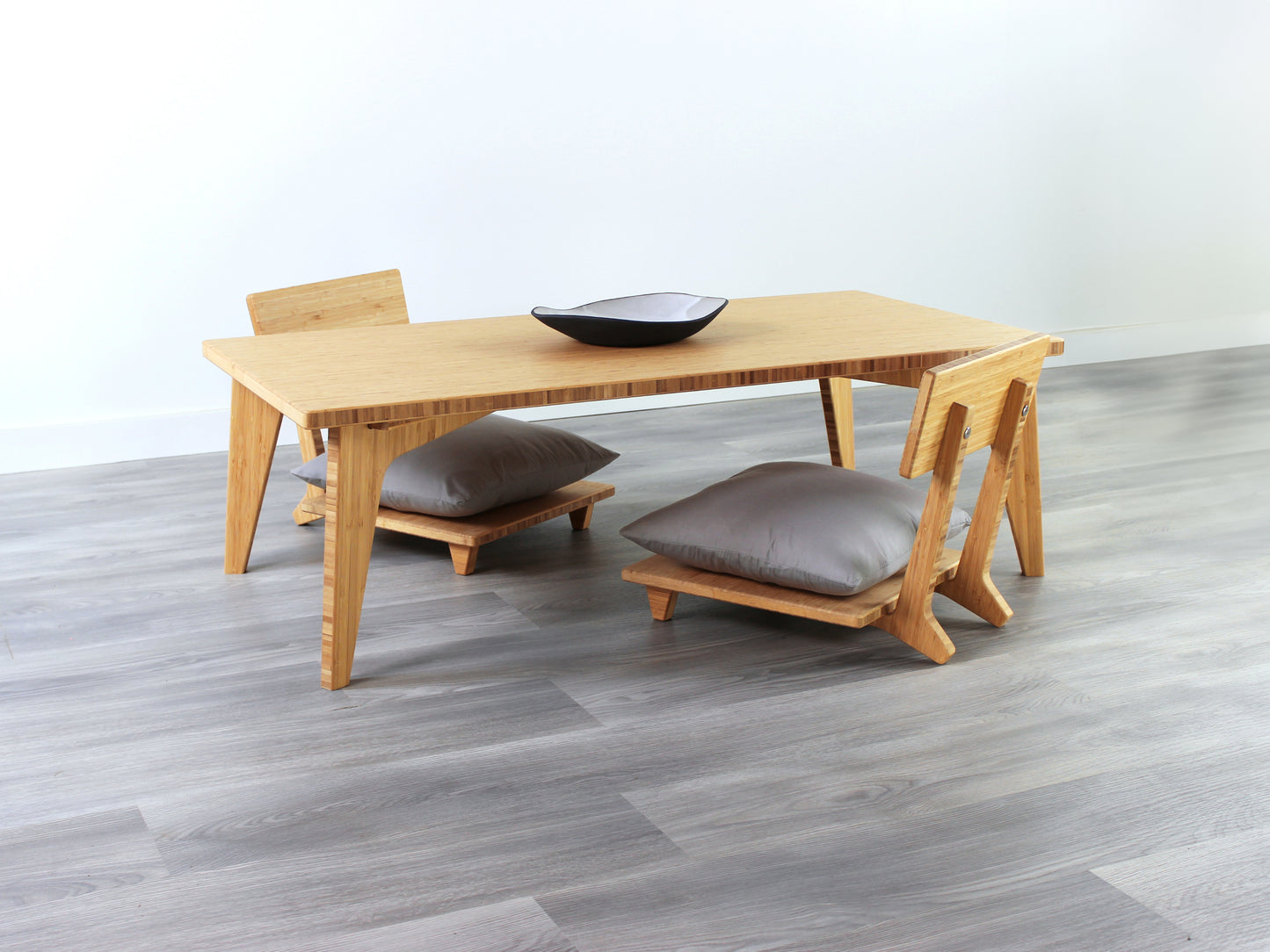 Small Rectangle Table Set - Natural, low table with Floor Chair Comfort set under with grey pillow. Set on a grey floor, against a white background. A small black pottery vessel is on the table top.
low table, coffee table, dining table, floor desk, floor chair, floor seating, low dining table, chabudai, tatami, kotatsu, minimalist, minimalist table,
modern