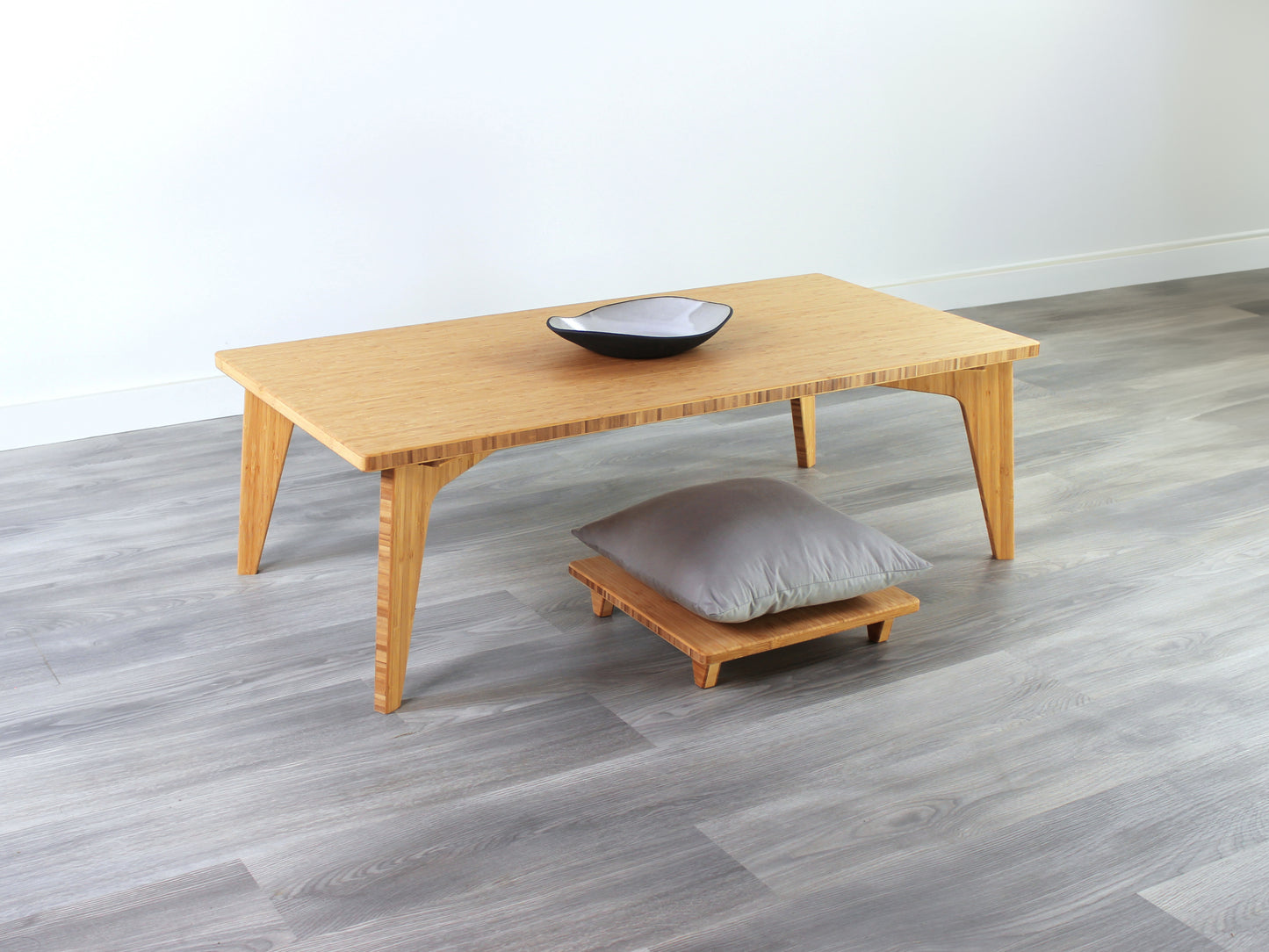 Small Rectangle Table Set - Chestnut, low table with Floor Chair Posture set under with grey pillow. Set on a grey floor, against a white background. A small black pottery vessel is on the table top.
low table, coffee table, dining table, floor desk, floor chair, floor seating, low dining table, chabudai, tatami, kotatsu, minimalist, minimalist table,
modern