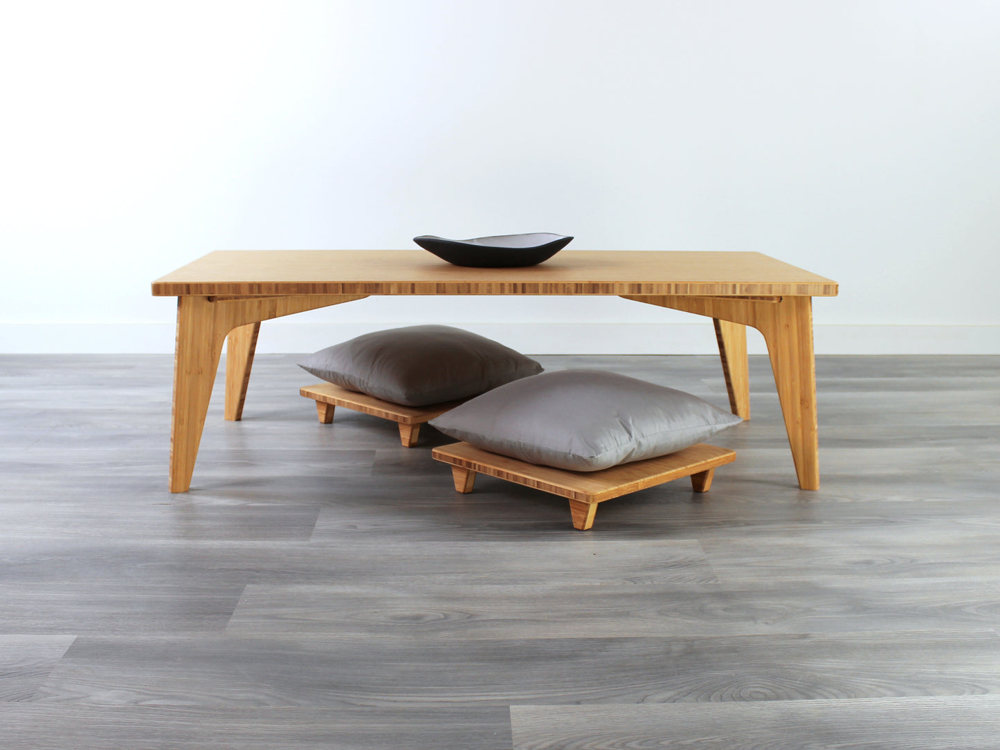 Small Rectangle Table Set - Chestnut, low table with Floor Chair Posture set under with grey pillow. Set on a grey floor, against a white background. A small black pottery vessel is on the table top.
low table, coffee table, dining table, floor desk, floor chair, floor seating, low dining table, chabudai, tatami, kotatsu, minimalist, minimalist table,
modern