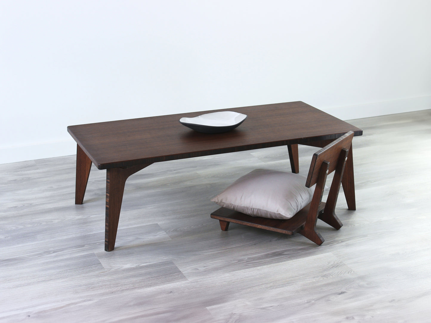 Small Rectangle Table Set - Walnut low table with Floor Chair Comfort set under with grey pillow. Set on a grey floor, against a white background. A small black pottery vessel is on the table top.
low table, coffee table, dining table, floor desk, floor chair, floor seating, low dining table, chabudai, tatami, kotatsu, minimalist, minimalist table,
modern