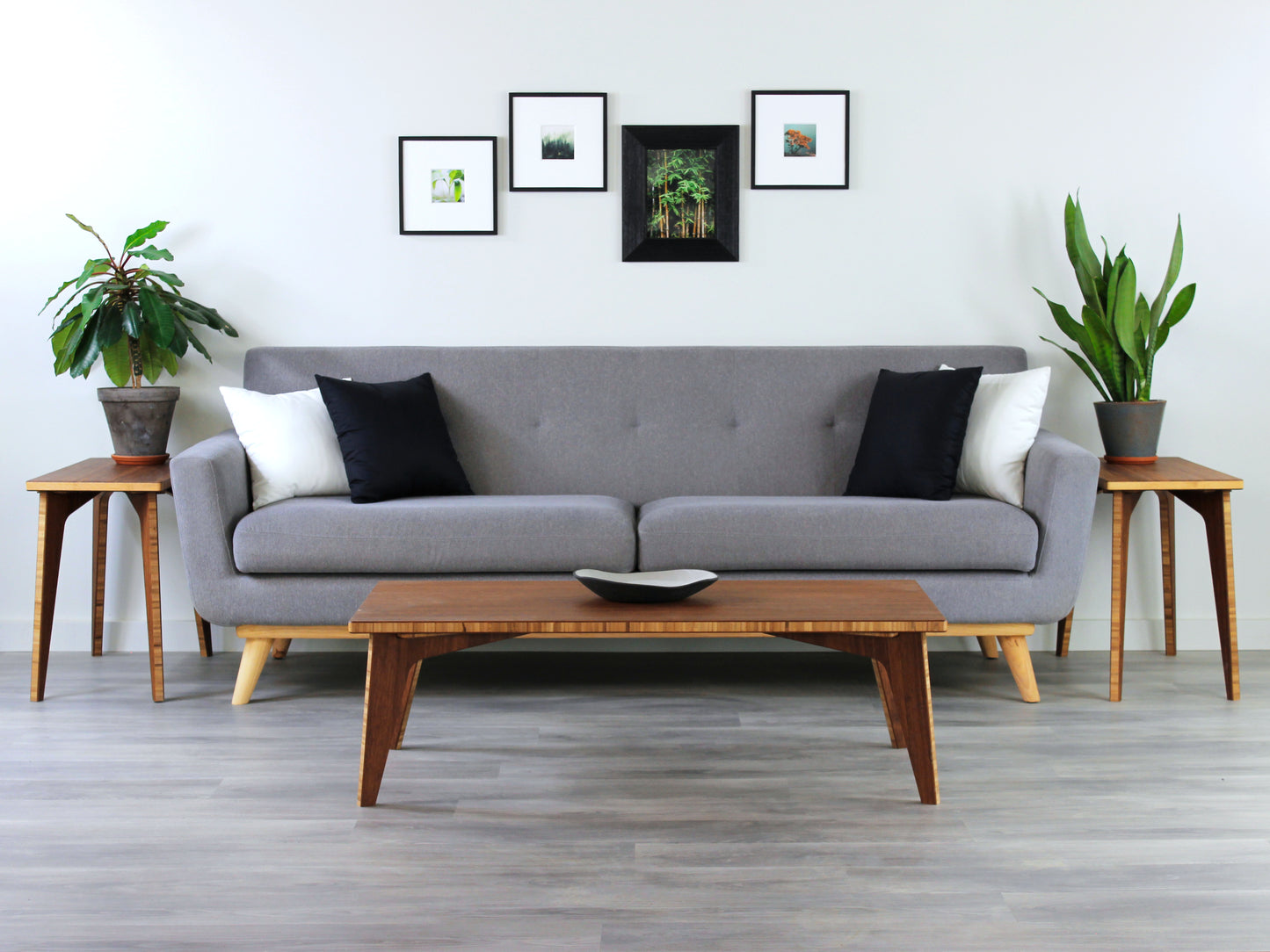 A small rectangular low table made of bamboo with a natural finish, placed on a grey floor with a white background. Set in a living room area, a grey couch and side tables with houseplants. A small black pottery vessel is placed on the table top.
japanese furniture
japanese low table
low coffee table
low dining table
low table
mid century
minimalist
minimalist table
modern
chabudai