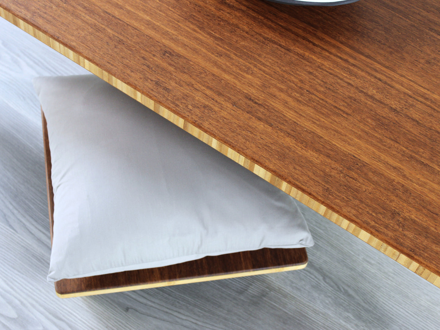 A small rectangular low table made of bamboo with a chestnut finish, placed on a grey floor with a white background. A small black pottery vessel is placed on the table top. Floor Chair Posture with a grey pillow is set underneath.
japanese furniture
japanese low table
low coffee table
low dining table
low table
mid century
minimalist
minimalist table
modern
chabudai