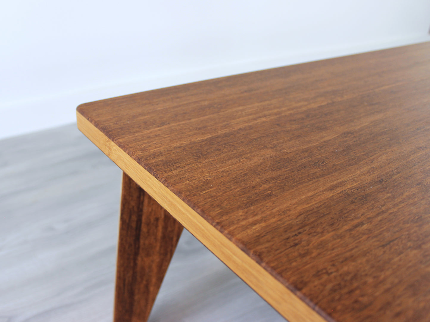 A small rectangular low table made of bamboo with a chestnut finish, placed on a grey floor with a white background.
japanese furniture
japanese low table
low coffee table
low dining table
low table
mid century
minimalist
minimalist table
modern
chabudai