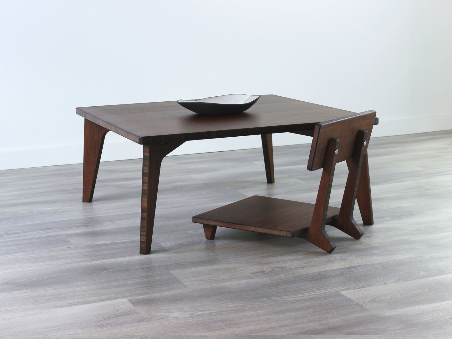 Small Square Table Set in walnut finish. A Floor Chair Comfort is placed below. A small black pottery vessel is placed on top of the table.
sustainable bamboo, renewable bamboo, solid bamboo, eco-friendly furniture, zero-waste, carbon neutral, natural materials, natural-based finish, repairable furniture