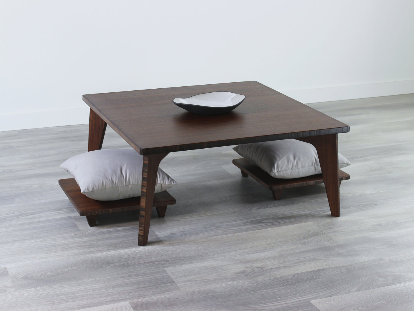 Small Square Table Set in walnut finish. Two Floor Chair Posture with grey pillows are placed below. A small black pottery vessel is placed on top of the table.
sustainable bamboo, renewable bamboo, solid bamboo, eco-friendly furniture, zero-waste, carbon neutral, natural materials, natural-based finish, repairable furniture