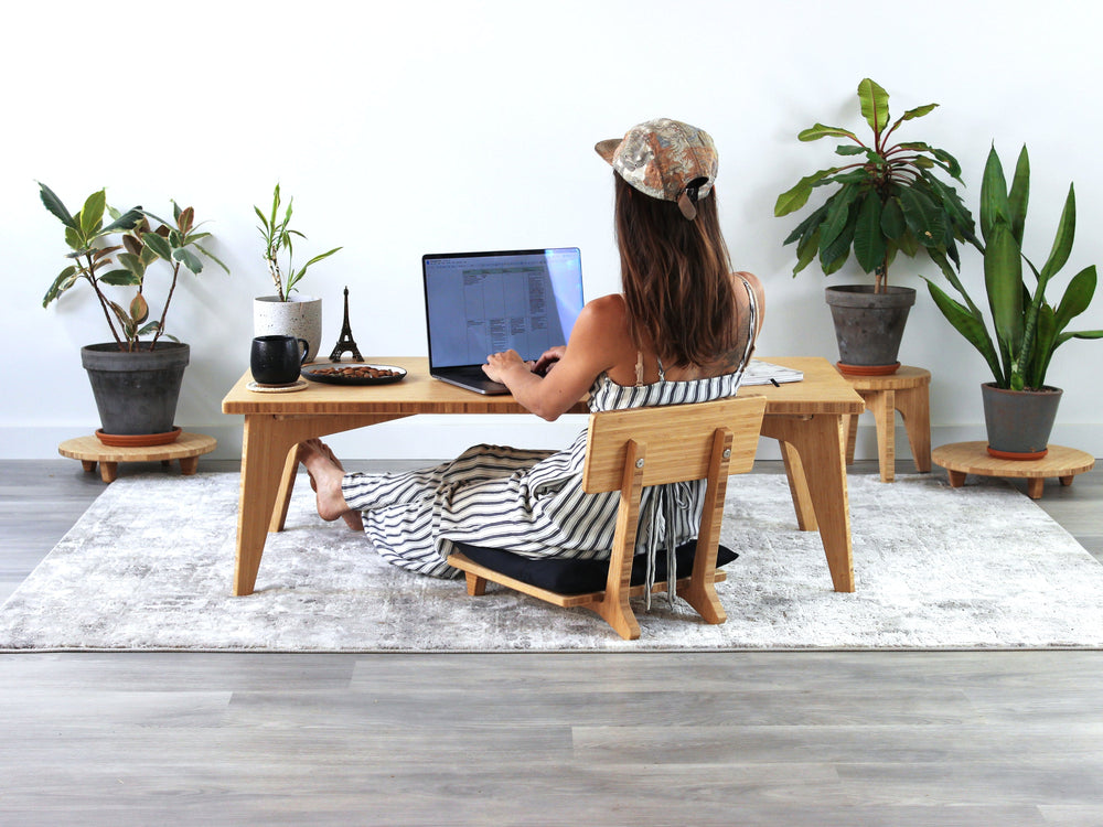 Bamboo floor desk designed for working while seated close to the ground.