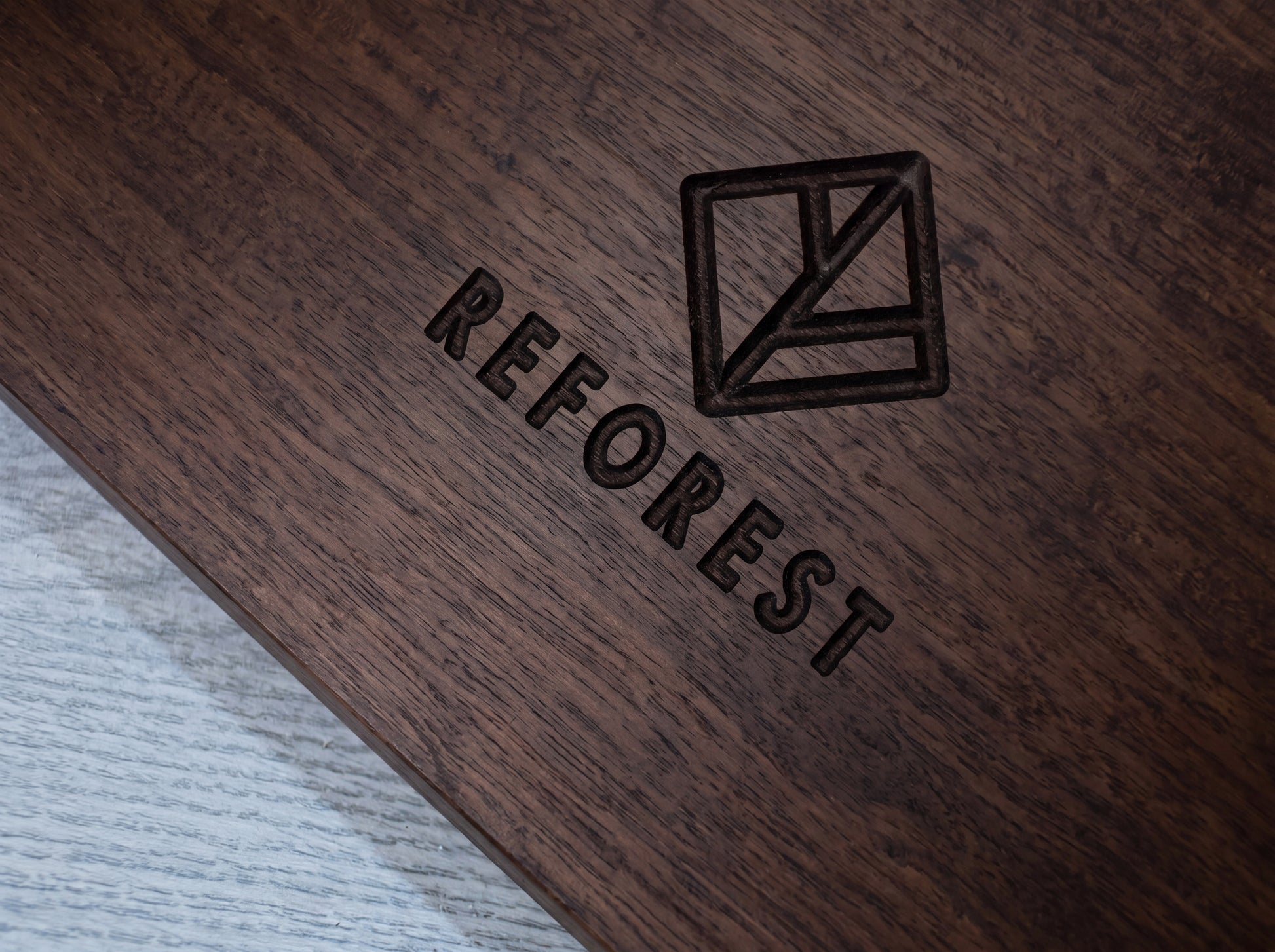 Bamboo surface with 'REFOREST' branding