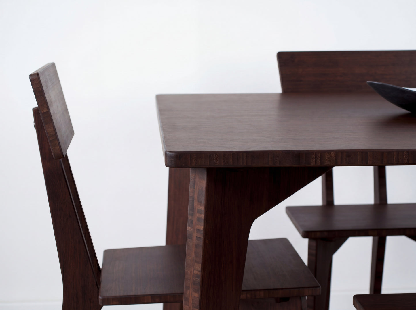 Bamboo dining table with chairs on a white background