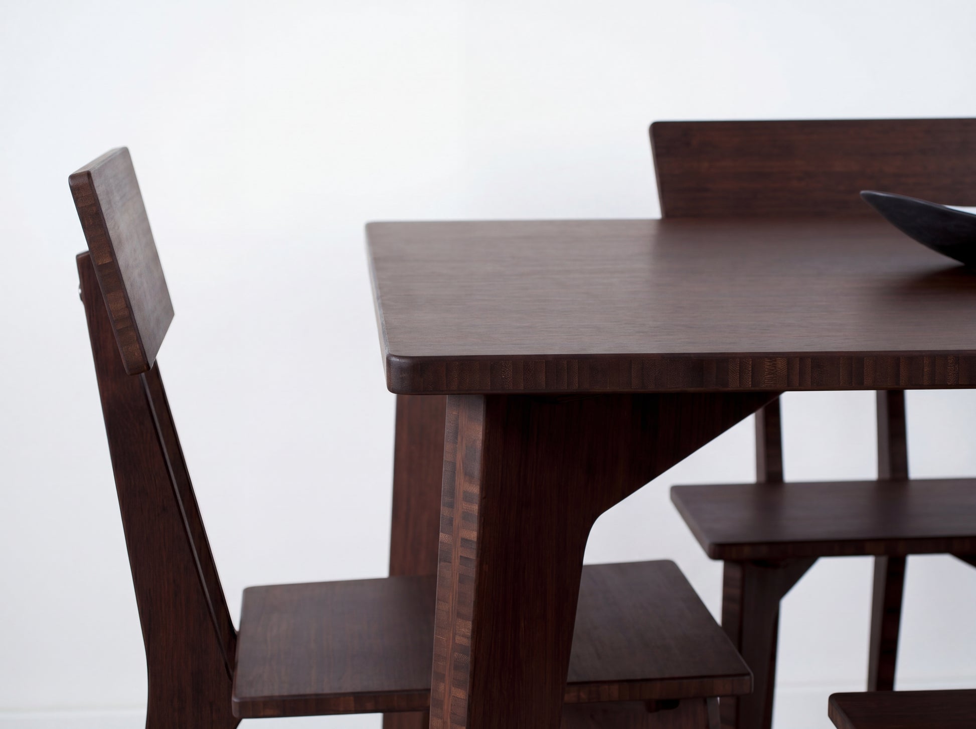 Bamboo dining table with chairs on a white background