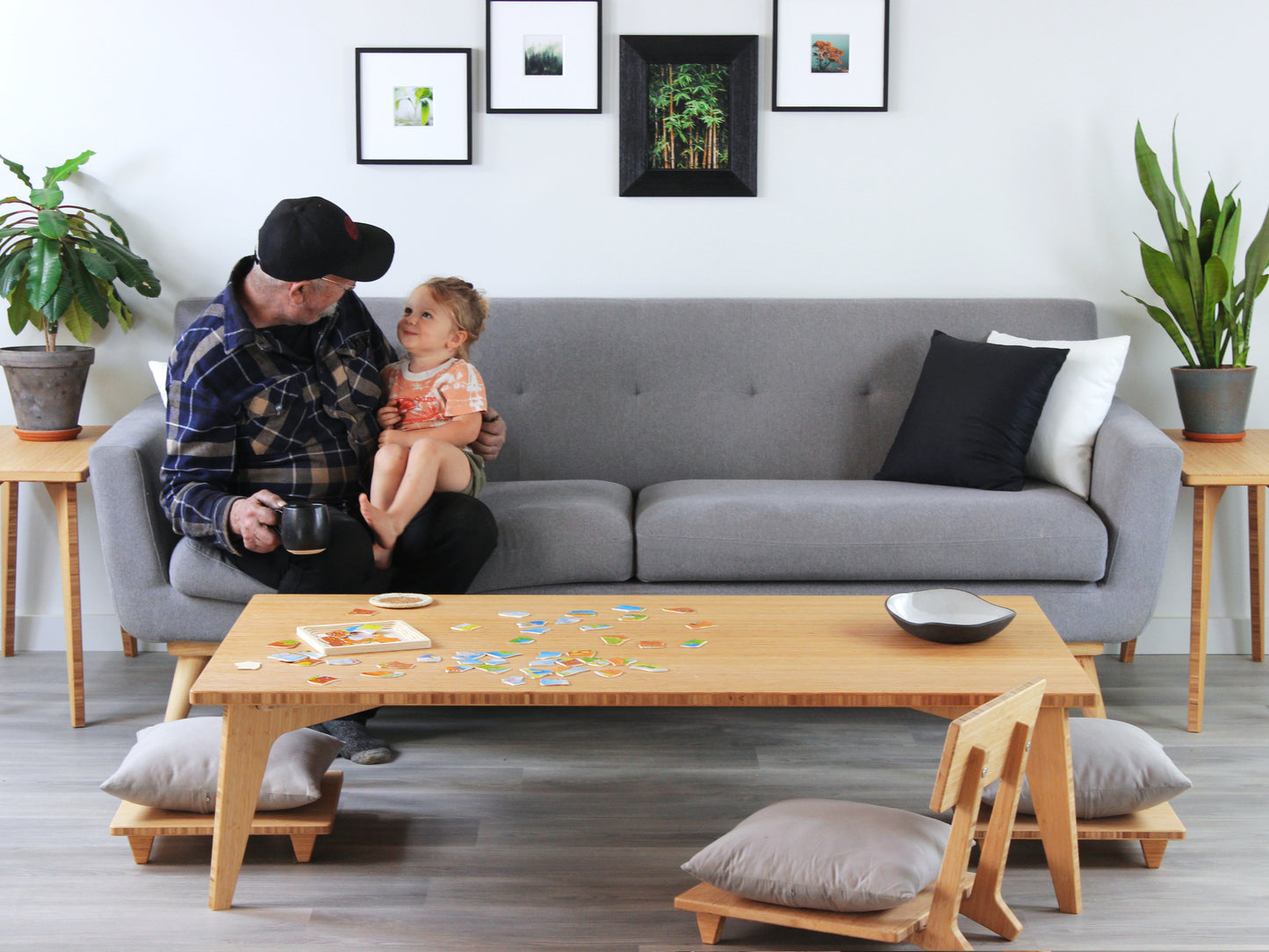 Grandpa and grandson sitting on a gray sofa in a living room with a bamboo coffee table.

Meditation Chair 
Japanese Tea Table 
Kotatsu
low chair
posture support 
ergonomic 
minimilist 