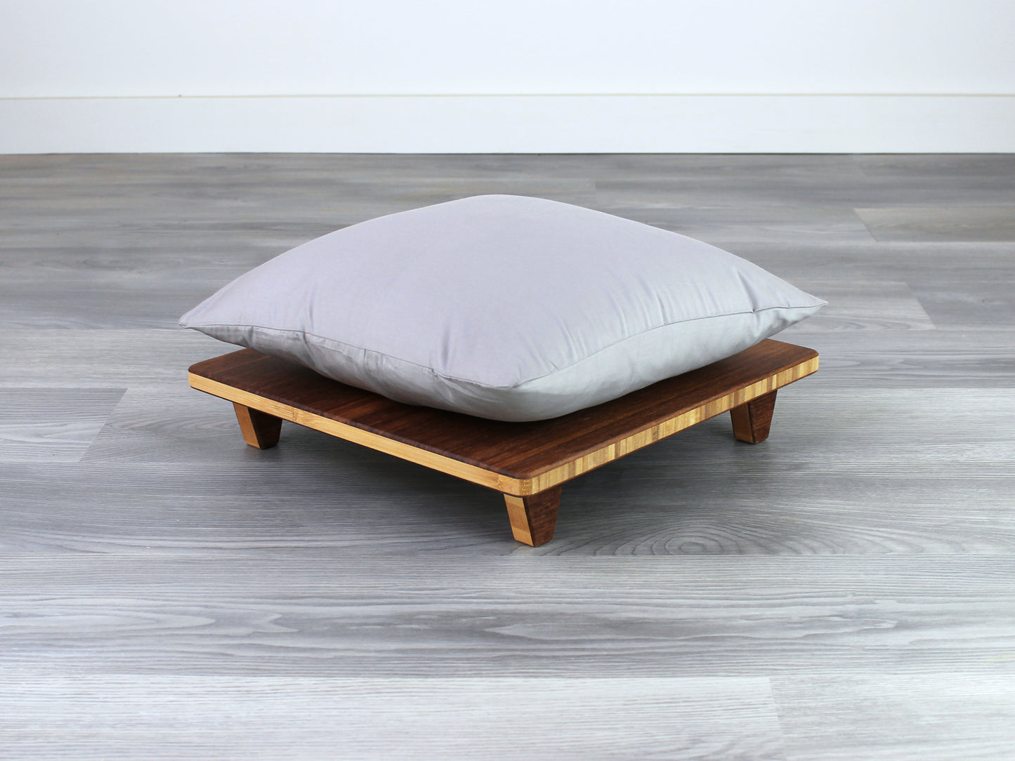 Chestnut Floor Chair Posture, placed on a grey floor and a white wall background. Grey pillow set on top. 

Meditation Chair 
Japanese Tea Table 
Kotatsu
low chair
posture support 
ergonomic 
minimilist
pillow lift