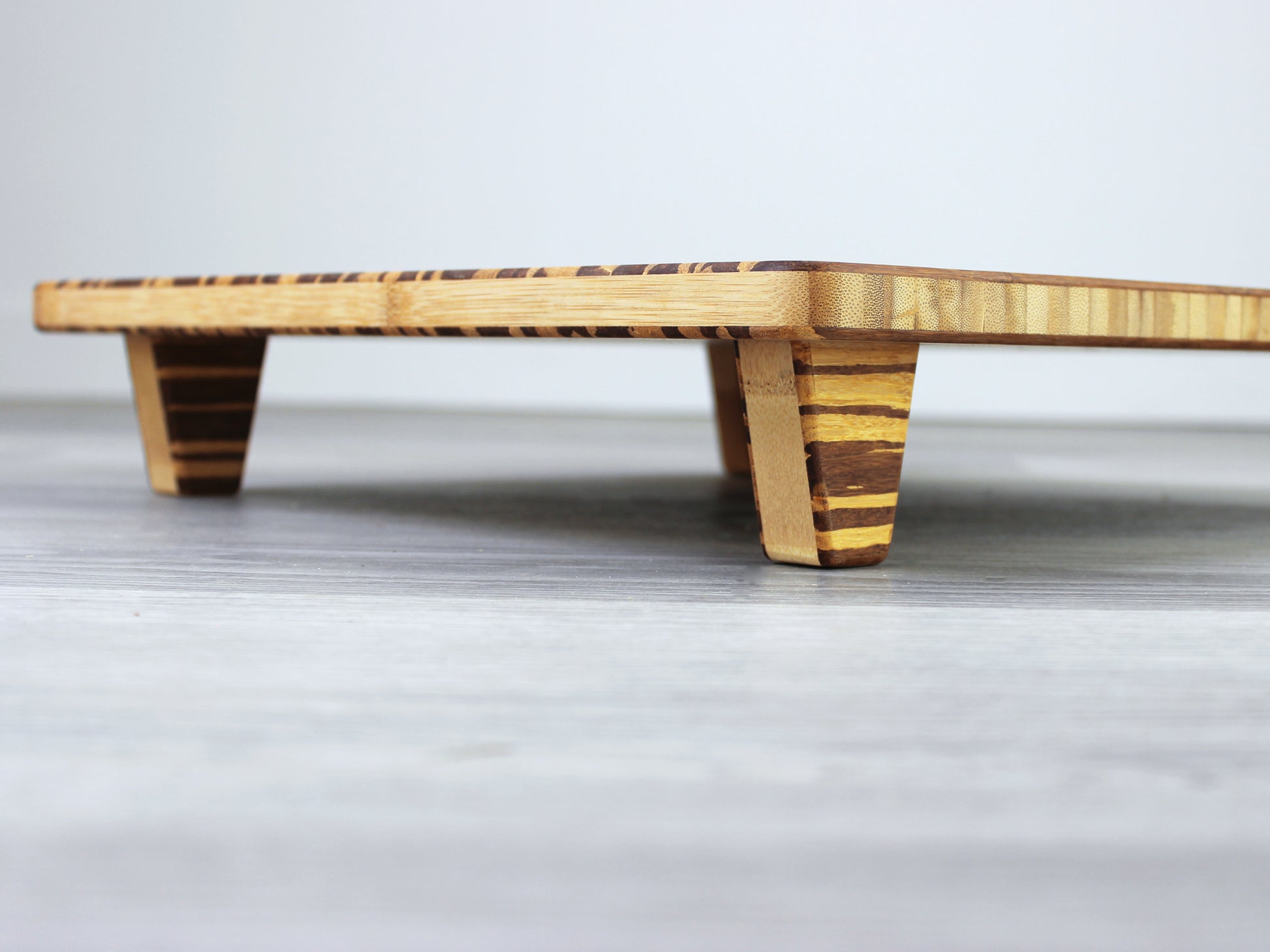 Tiger Floor Chair Posture, placed on a grey floor and a white wall background. 

Meditation Chair 
Japanese Tea Table 
Kotatsu
low chair
posture support 
ergonomic 
minimilist