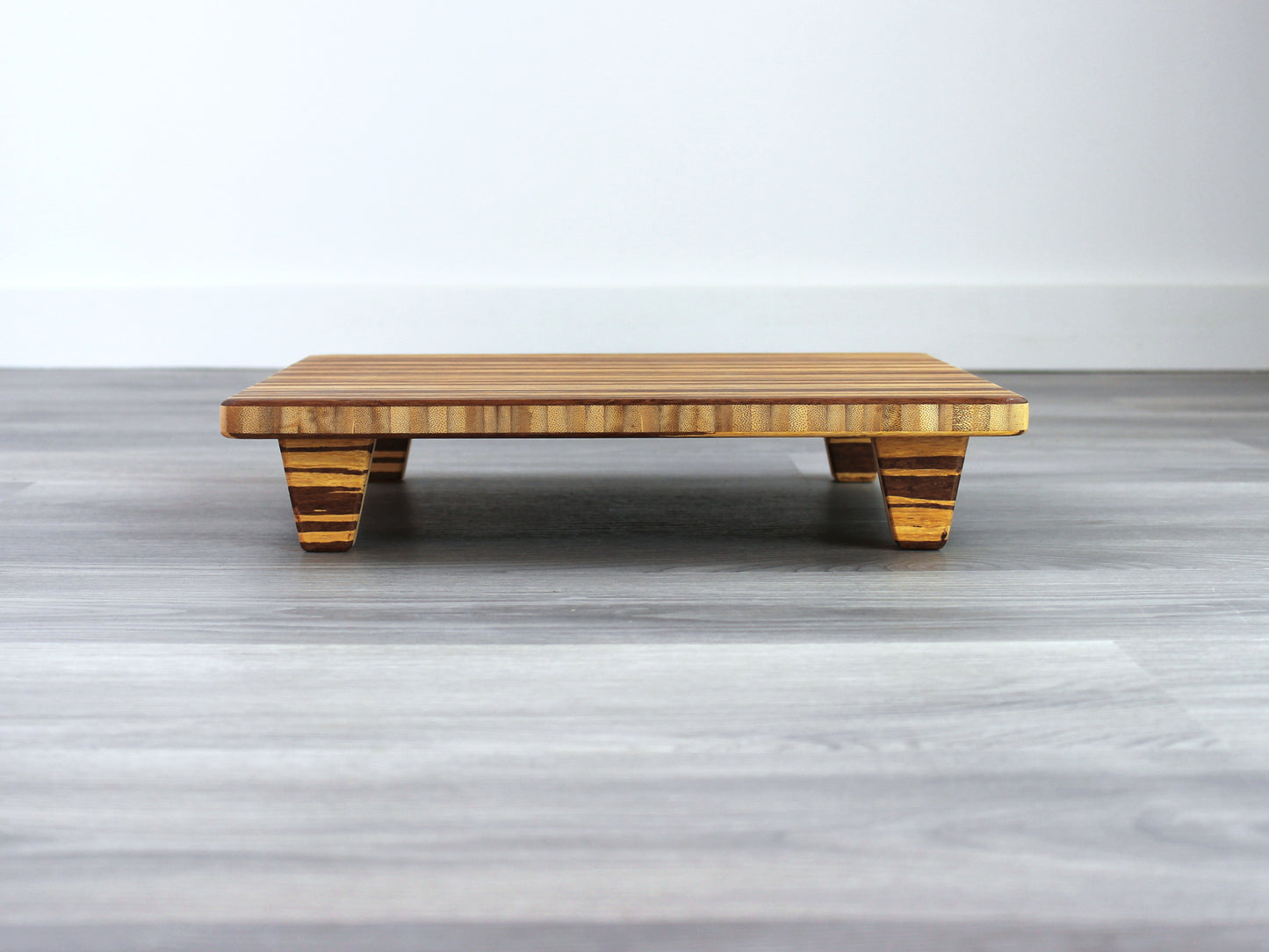 Tiger Floor Chair Posture, placed on a grey floor and a white wall background. 

Meditation Chair 
Japanese Tea Table 
Kotatsu
low chair
posture support 
ergonomic 
minimilist