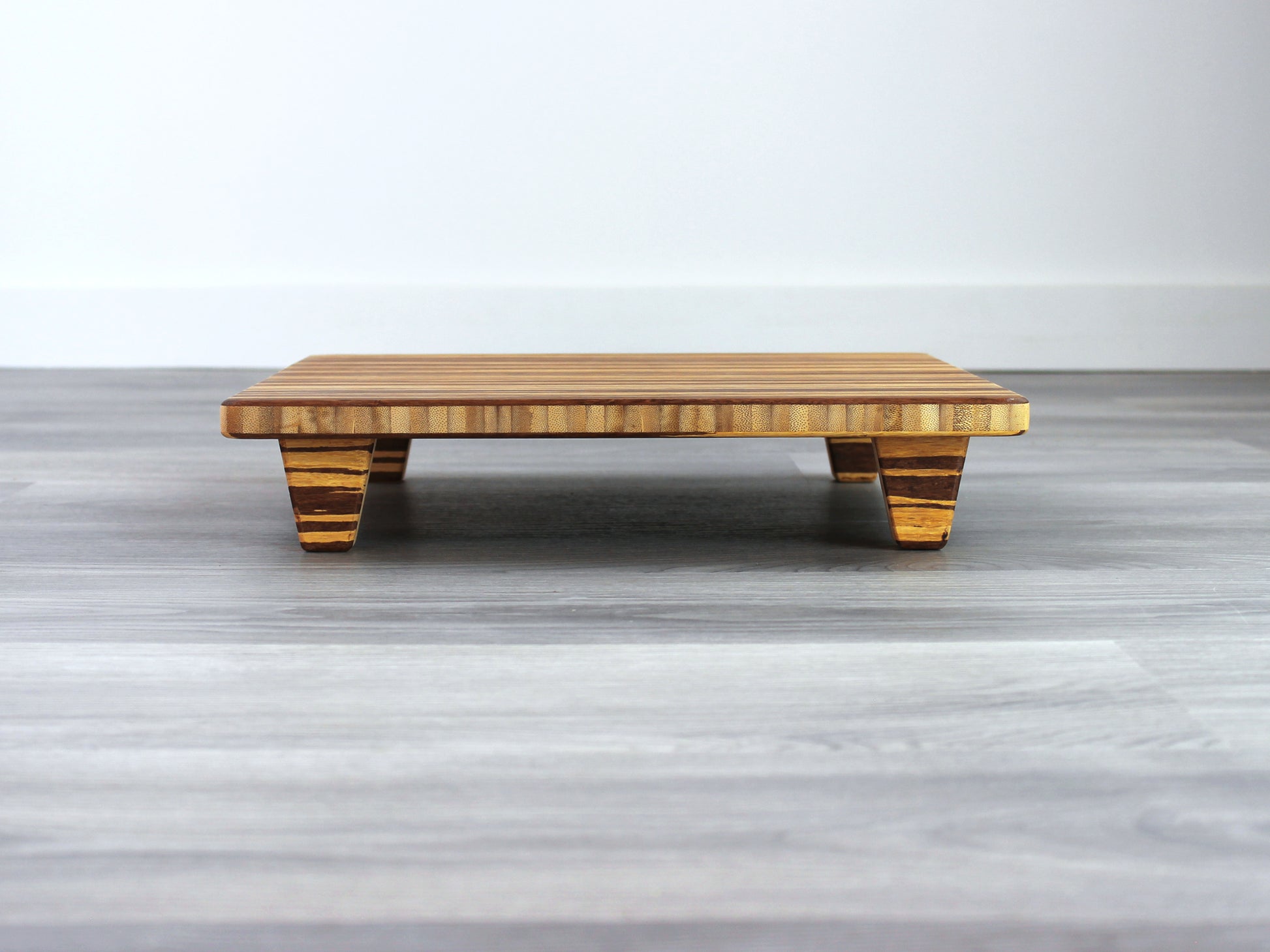Tiger Floor Chair Posture, placed on a grey floor and a white wall background. 

Meditation Chair 
Japanese Tea Table 
Kotatsu
low chair
posture support 
ergonomic 
minimilist