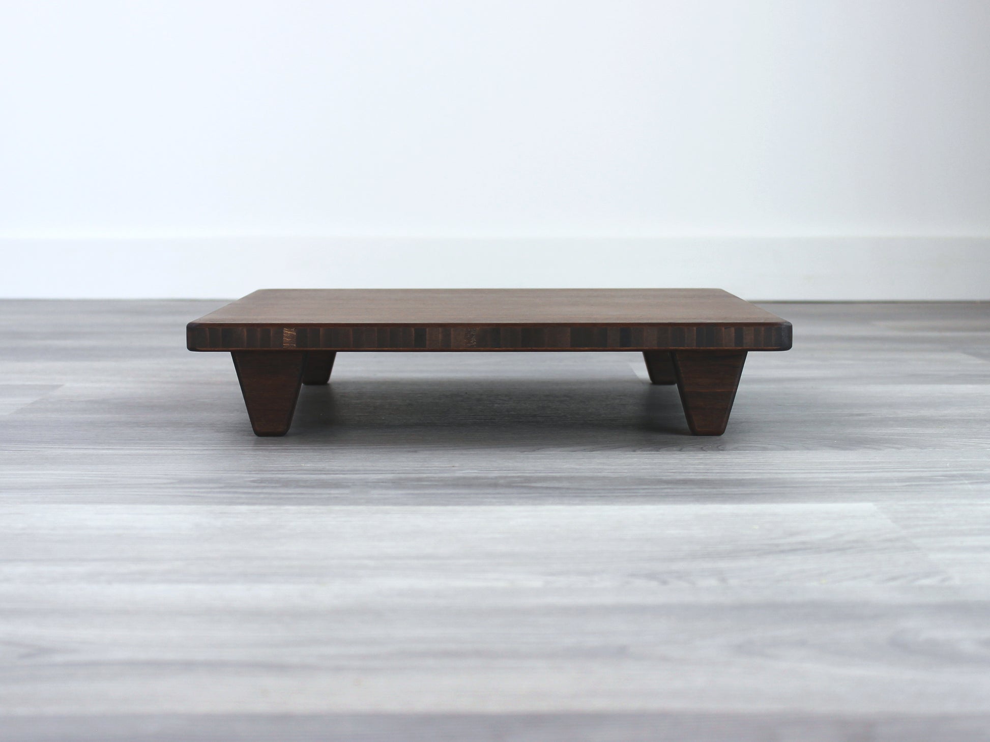Walnut Floor Chair Posture, placed on a grey floor and a white wall background. 

Meditation Chair 
Japanese Tea Table 
Kotatsu
low chair
posture support 
ergonomic 
minimilist