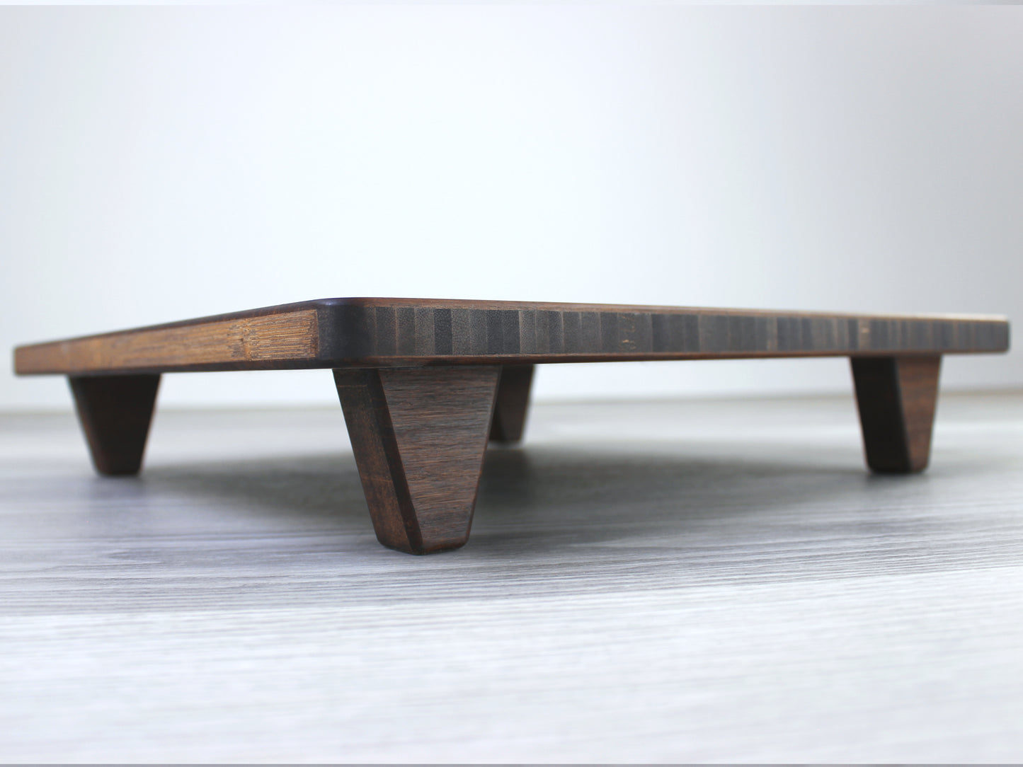 Walnut Floor Chair Posture, placed on a grey floor and a white wall background. 

Meditation Chair 
Japanese Tea Table 
Kotatsu
low chair
posture support 
ergonomic 
minimilist