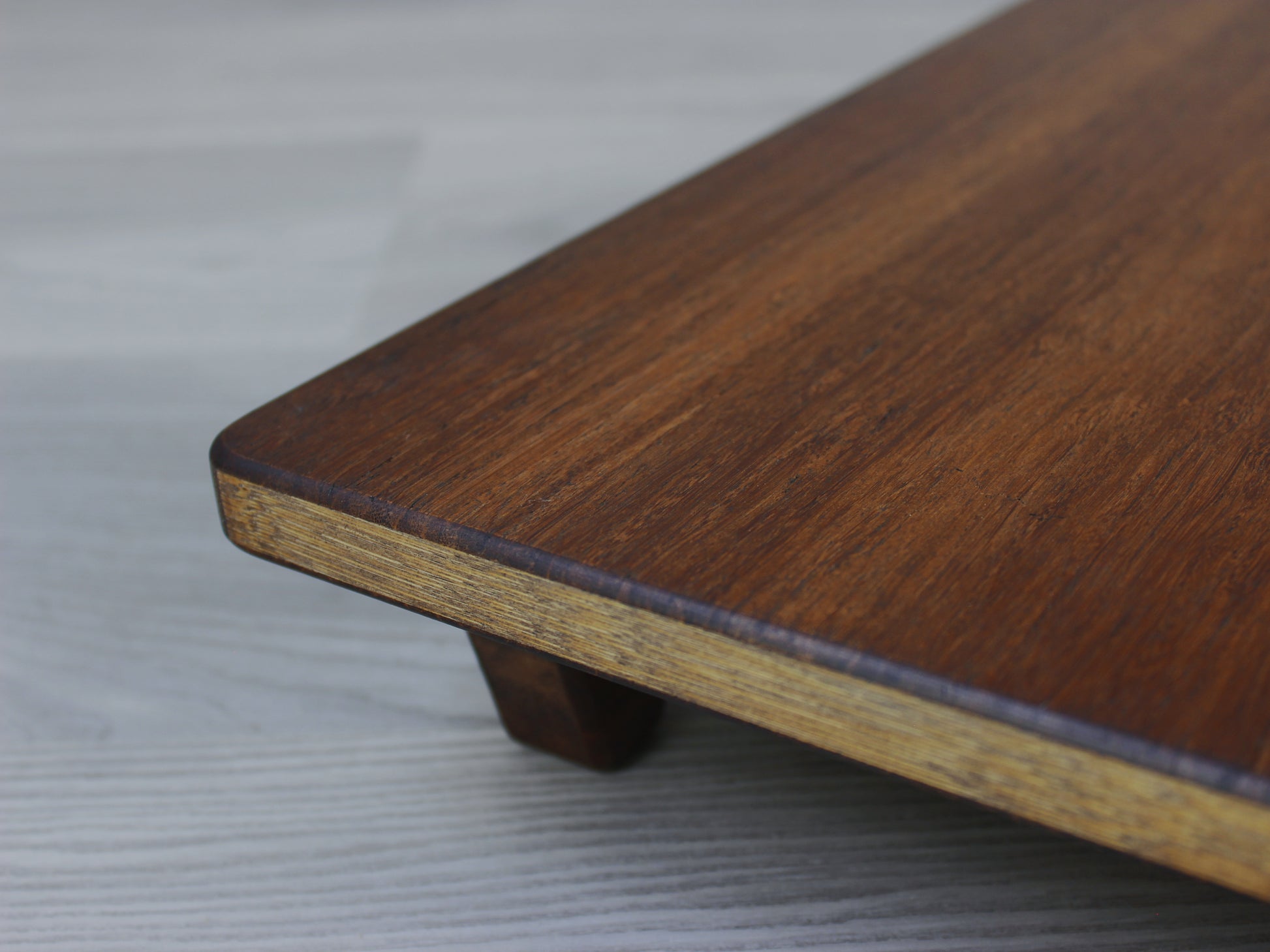 Walnut Floor Chair Posture, placed on a grey floor and a white wall background. 

Meditation Chair 
Japanese Tea Table 
Kotatsu
low chair
posture support 
ergonomic 
minimilist