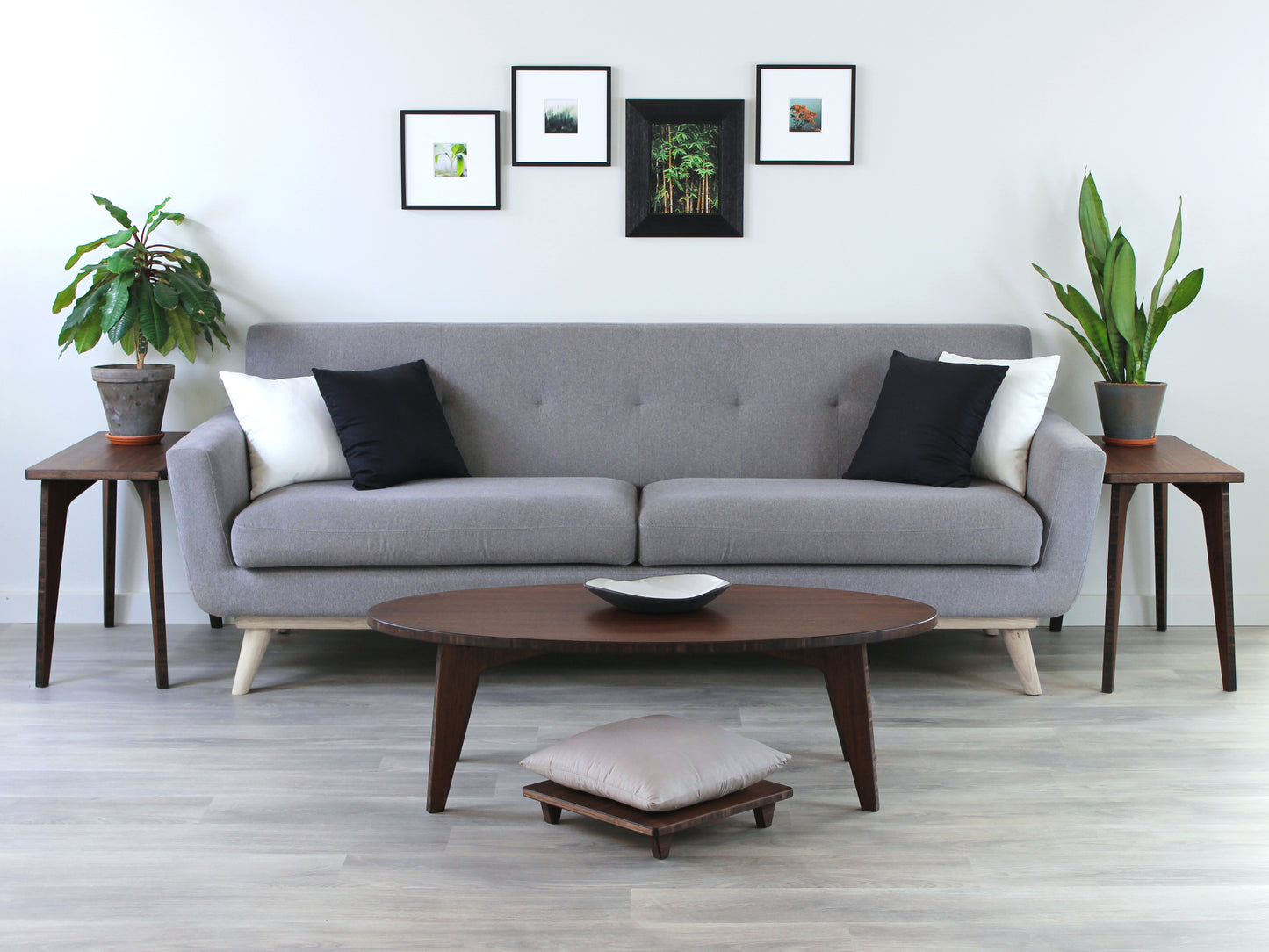 Walnut Floor Chair Posture, placed on a grey floor with a grey pillow on top. Set at a LOW Table in a living room setting. Grey couch with Side Tables against a white wall background. 

Meditation Chair 
Japanese Tea Table 
Kotatsu
low chair
posture support 
ergonomic 
minimilist