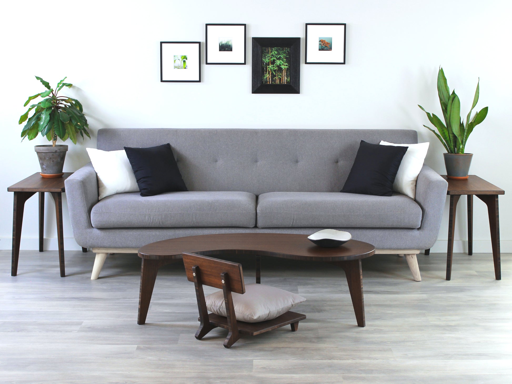A Kidney LOW Table Set in walnut bamboo, featuring a small black and white pottery vessel placed on top. Floor Chair Comfort with a grey pillow set underneath. Placed on a Grey flooring with a white background. 

mid century modern low table
midcentury modern coffee table
floor table
japan coffee table
japan furniture
japan table
kidney coffee table 
bamboo low seating