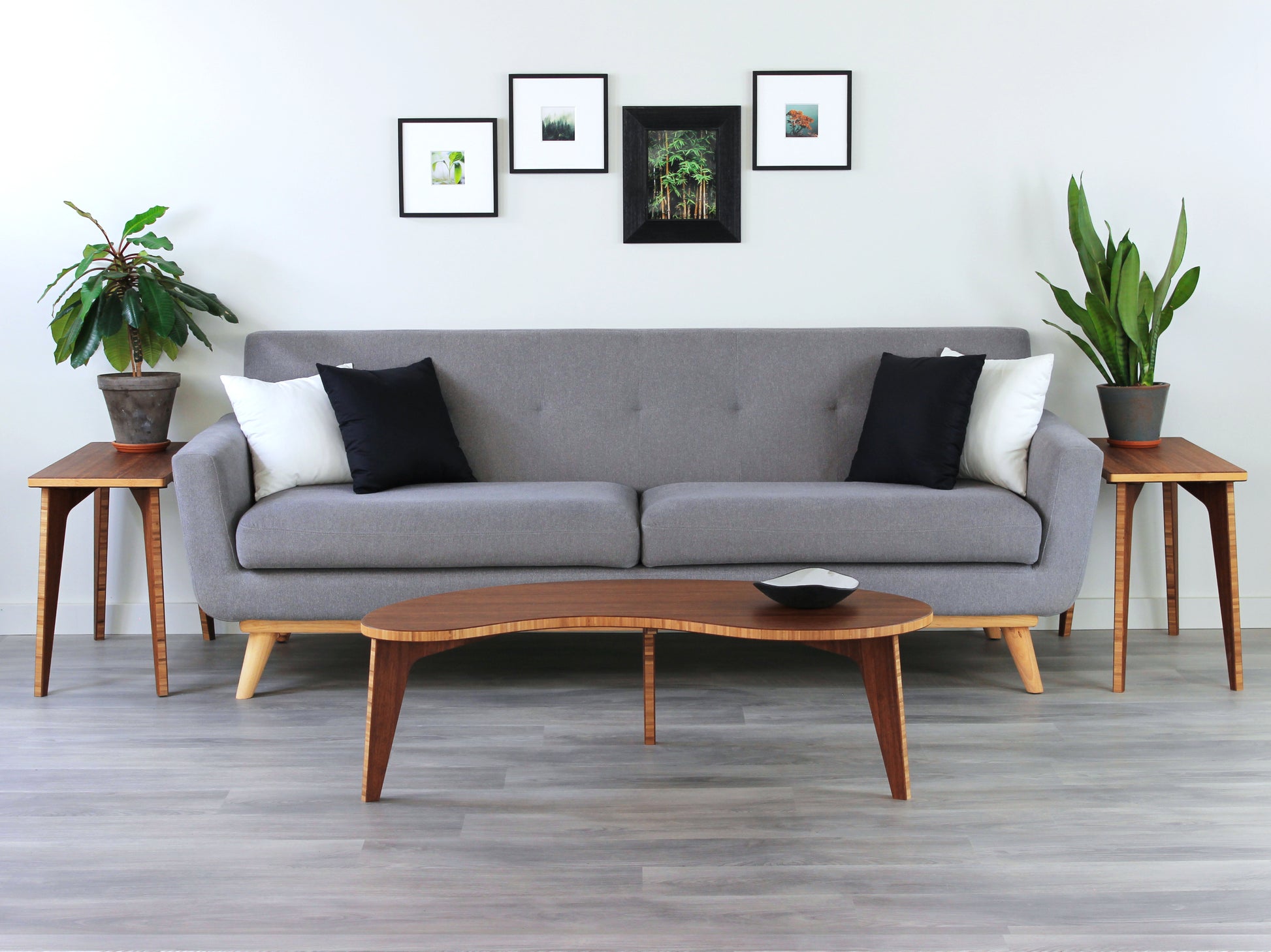 Kidney table in bamboo with a chestnut color finish, featuring a Japandi style design, set on a grey floor with a white background. Set in a living room area, a grey couch and side tables with houseplants. A small black pottery vessel is placed on the table top. 

mid century modern low table
midcentury modern coffee table
floor table
japan coffee table
japan furniture
japan table
kidney coffee table 
bamboo low table
