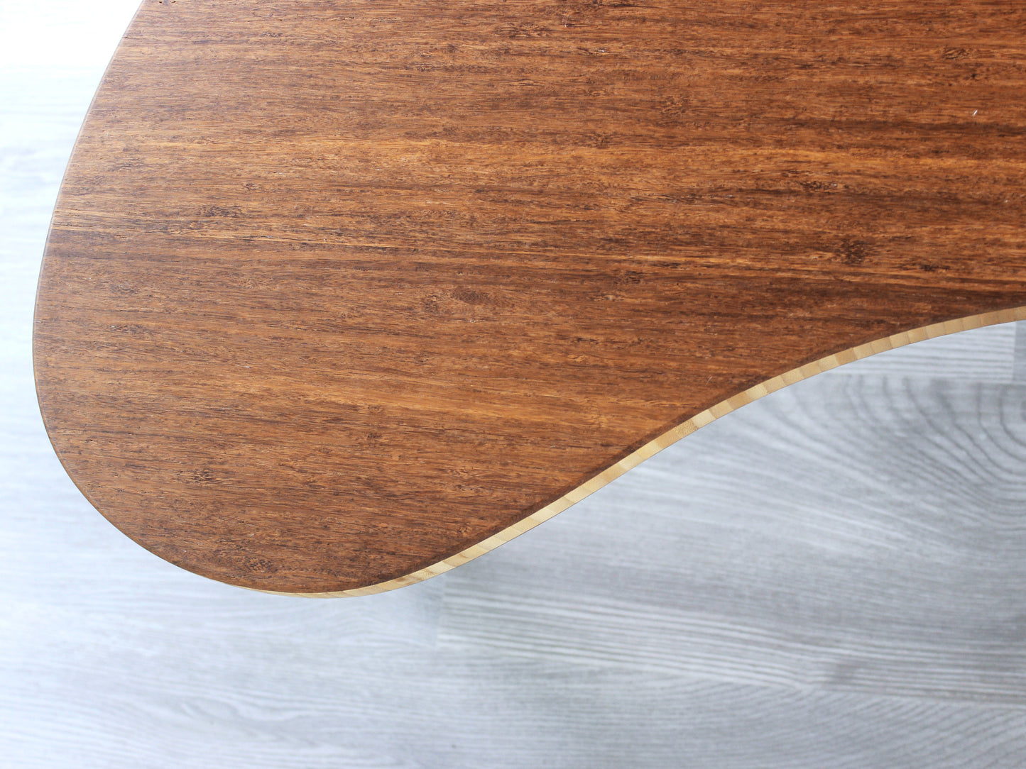 A small kidney-shaped chestnut bamboo table, overhead view. Grey flooring with a white background. 

mid century modern low table
midcentury modern coffee table
floor table
japan coffee table
japan furniture
japan table
kidney coffee table 
bamboo low table