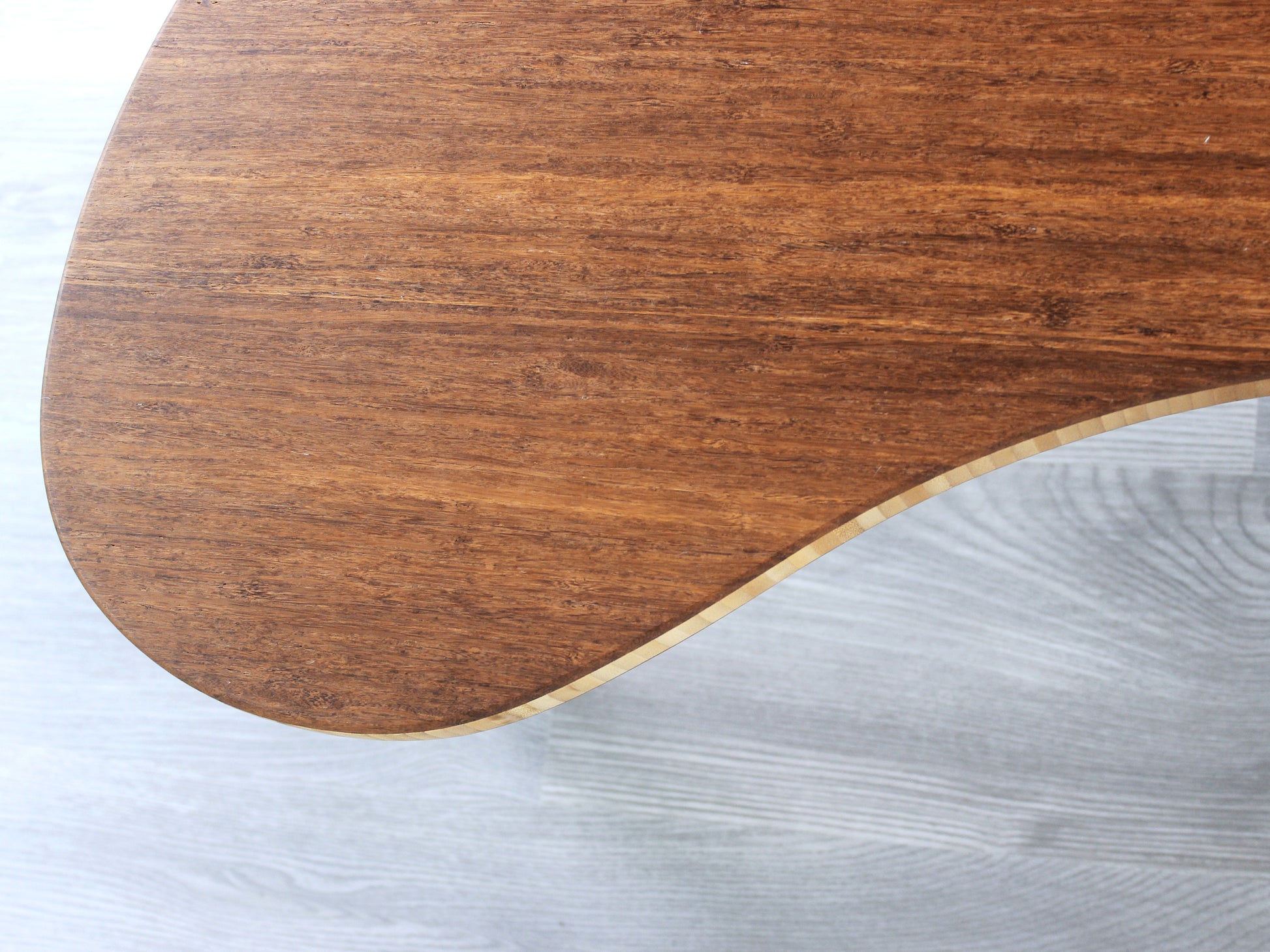 A small kidney-shaped chestnut bamboo table, overhead view. Grey flooring with a white background. 

mid century modern low table
midcentury modern coffee table
floor table
japan coffee table
japan furniture
japan table
kidney coffee table 
bamboo low table