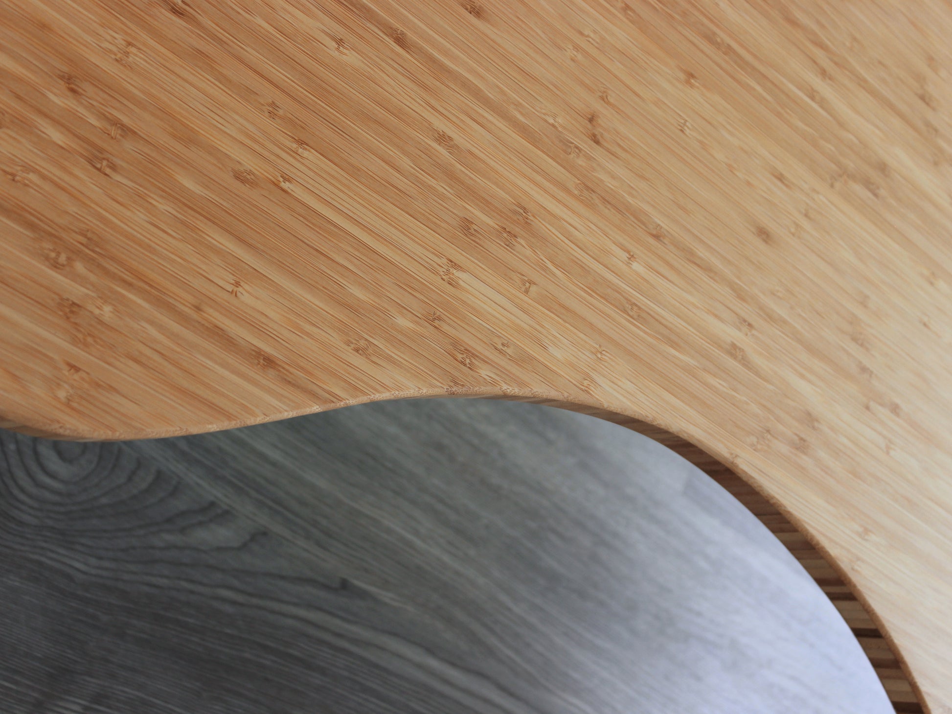 A kidney-shaped natural bamboo table, overhead view. Grey flooring with a white background. 

mid century modern low table
midcentury modern coffee table
floor table
japan coffee table
japan furniture
japan table
kidney coffee table 
bamboo low table