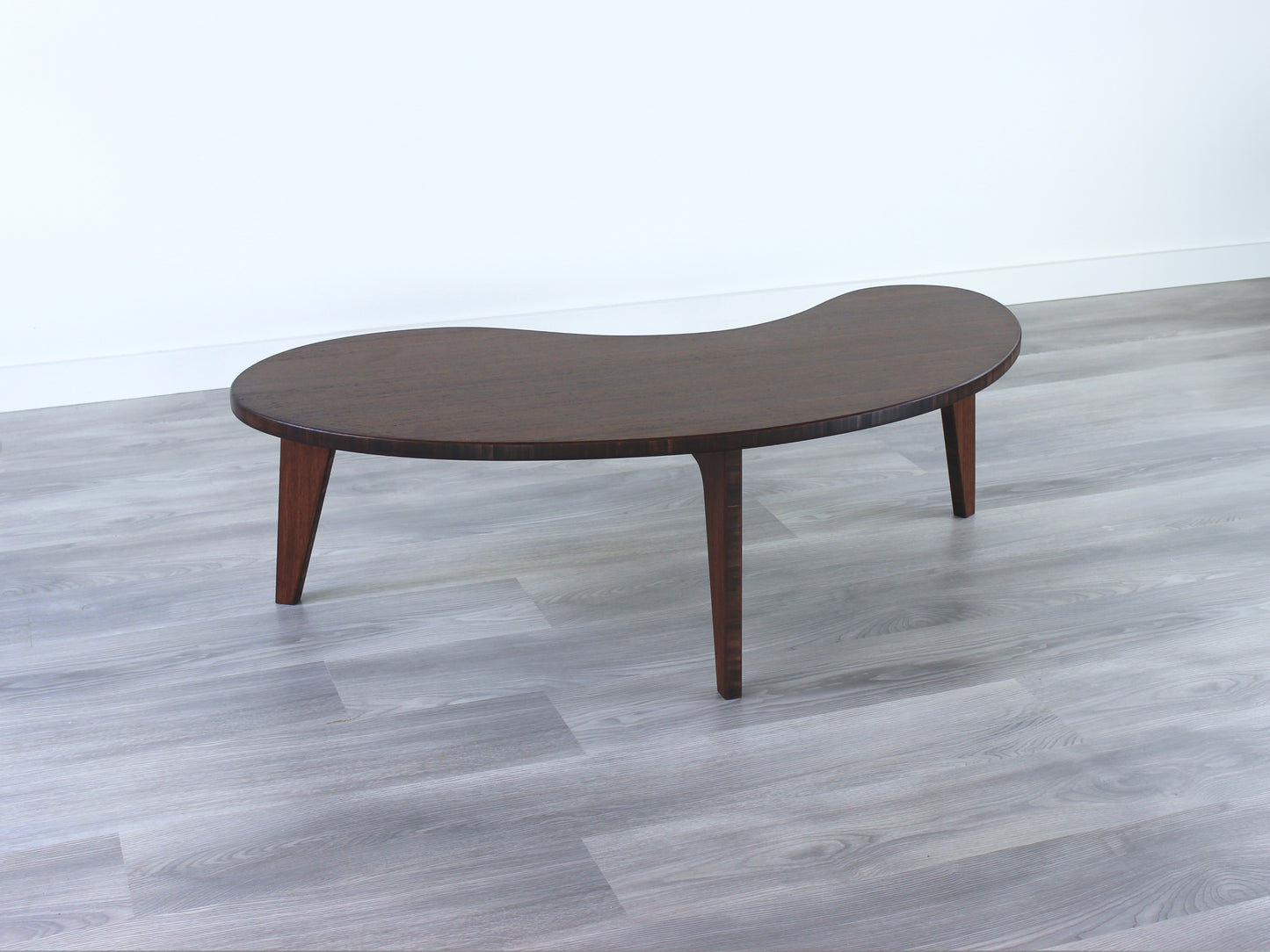A kidney-shaped walnut bamboo table. Grey flooring with a white background. 

mid century modern low table
midcentury modern coffee table
floor table
japan coffee table
japan furniture
japan table
kidney coffee table 
bamboo low table