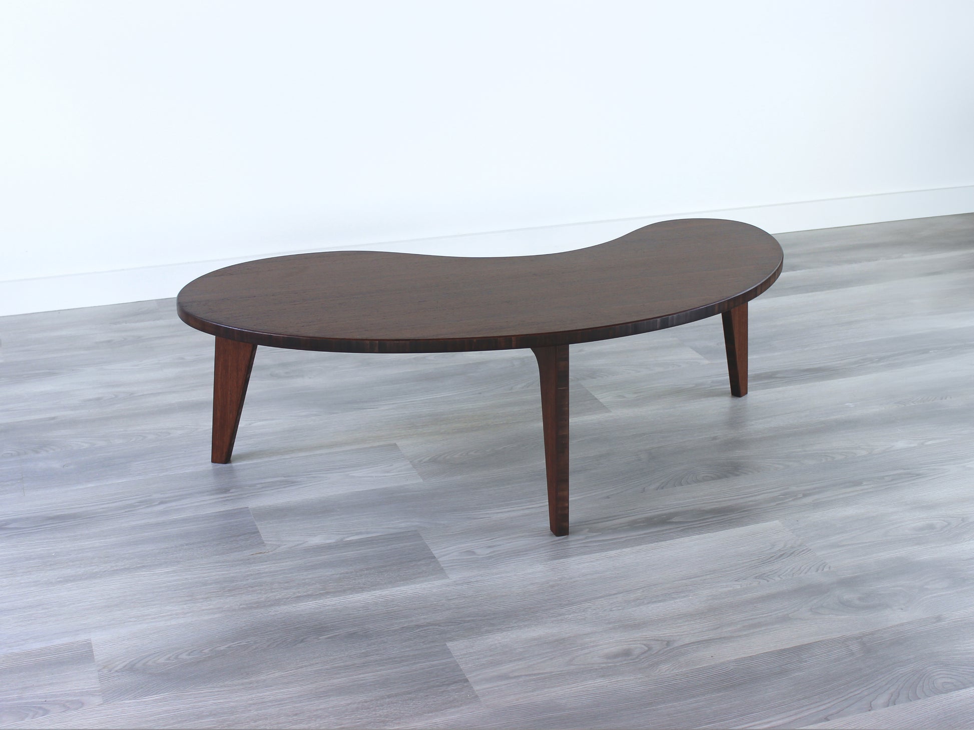 A kidney-shaped walnut bamboo table. Grey flooring with a white background. 

mid century modern low table
midcentury modern coffee table
floor table
japan coffee table
japan furniture
japan table
kidney coffee table 
bamboo low table