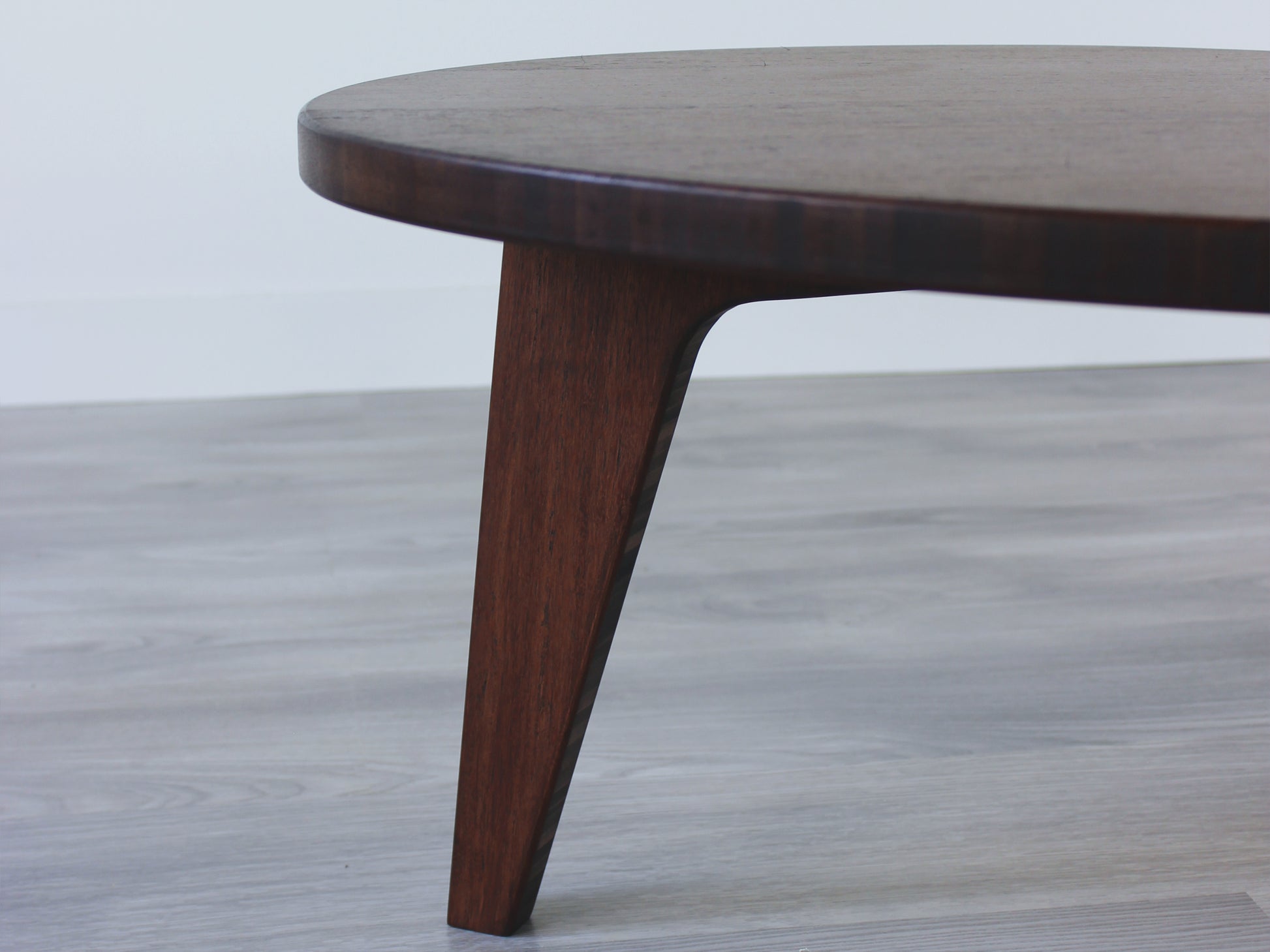 A kidney-shaped walnut bamboo table. Grey flooring with a white background. 

mid century modern low table
midcentury modern coffee table
floor table
japan coffee table
japan furniture
japan table
kidney coffee table 
bamboo low table