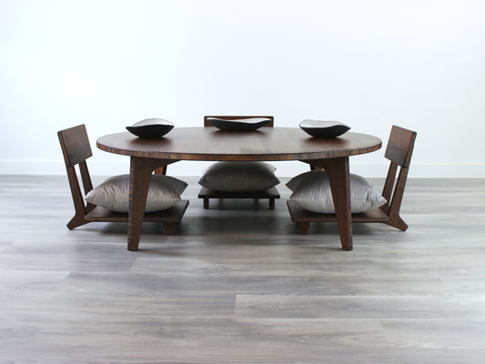 Large Circle Low Table with a walnut bamboo finish and midcentury modern design. Three Floor Chair Comfort with a grey pillow are set at the table. Small black pottery vessel placed on table top. 

Japandi, minimalist, mid-century, Japanese inspired, modern, contemporary, clean lines, organic design, sustainable bamboo, renewable bamboo, solid bamboo, eco-friendly furniture, natural materials, natural-based finish