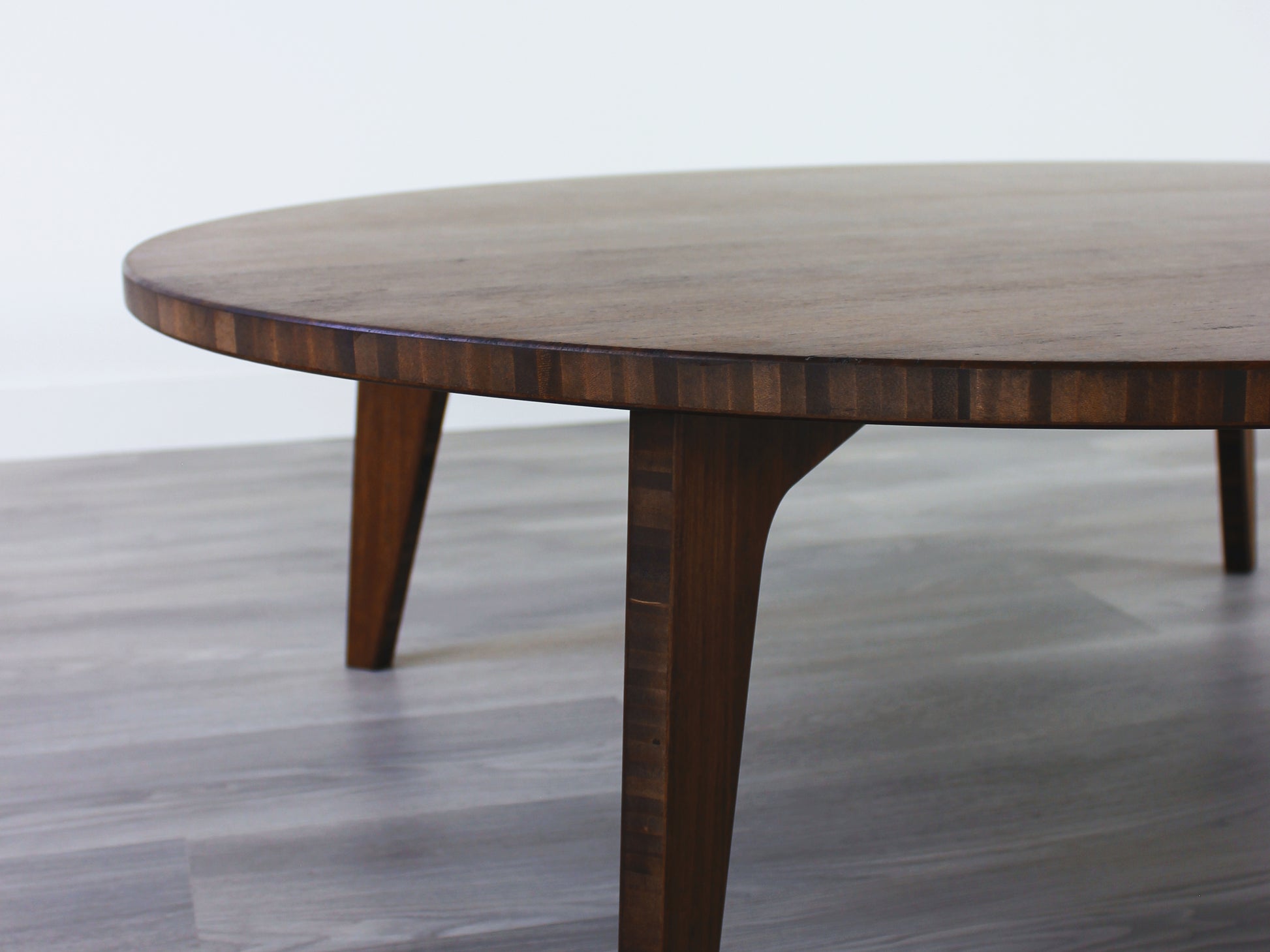 A round, walnut-colored bamboo table with a flat surface and curved legs on a gray floor.

Square low table 
japanese furniture
japanese low table
low coffee table
low dining table
low table
mid century
minimalist
minimalist table
modern
chabudai
kotatsu
large coffee table
