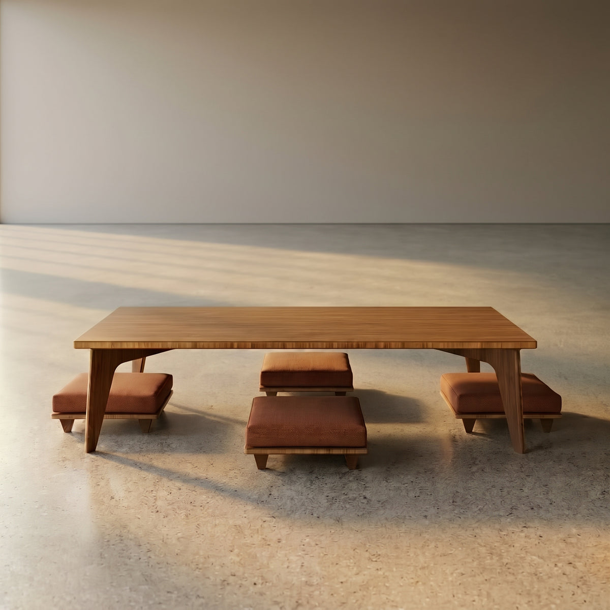 A minimalist low Reforest bamboo table featuring four low chairs with cushions in a big empty room.