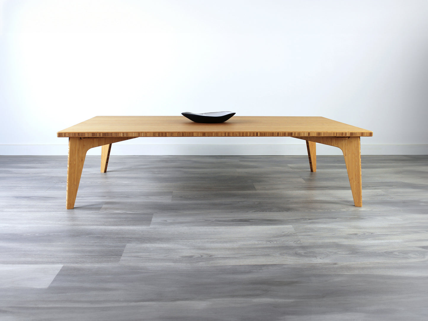 A rectangular low table made of bamboo with a natural finish, placed on a grey floor, designed for multi-functional use in living spaces. Small pottery vessel on table top.

japanese furniture
japanese low table
low coffee table
low dining table
low table
mid century
minimalist
minimalist table
modern