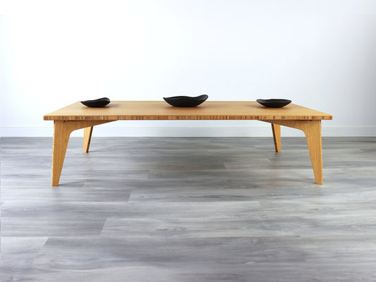 A rectangular low table made of bamboo with a natural finish, placed on a grey floor, designed for multi-functional use in living spaces. Three small black pottery vessels on the table top.

japanese furniture
japanese low table
low coffee table
low dining table
low table
mid century
minimalist
minimalist table
modern
floor dining table
floor table
japan coffee table