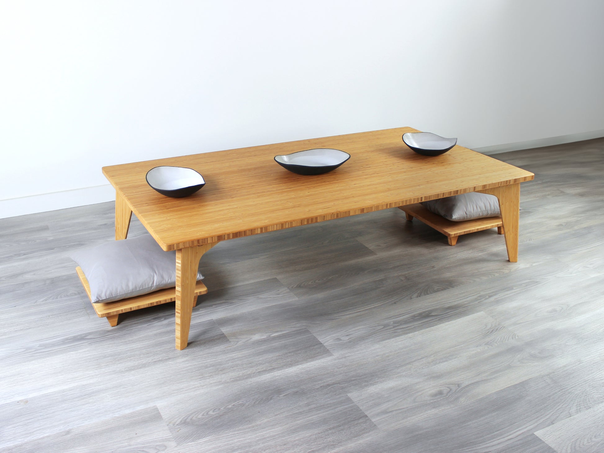 Large Rectangle Table Set - Natural low table with 2 Floor Chair Posture with grey pillows placed underneath. Set on a grey floor, against a white background. Multiple small black pottery vessels are on the table top. 

low table, coffee table, dining table, floor desk, floor chair, floor seating, low dining table, chabudai, tatami, kotatsu, minimalist, minimalist table,
modern, japanese low table, japanese table, kotatsu, large coffee table,
large dining table
