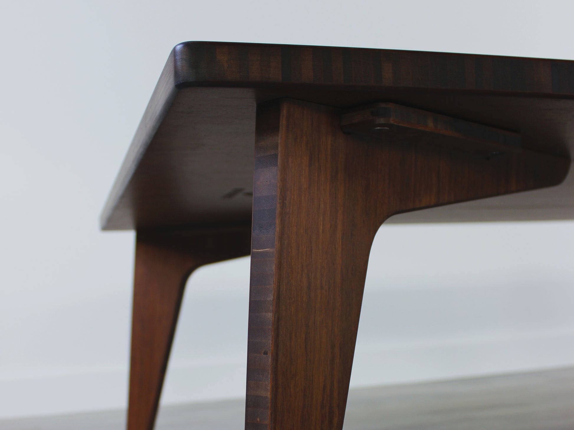 A large rectangular low table made of bamboo with a walnut finish, placed on a grey floor, designed for multi-functional use in living spaces. An underside view.

japanese furniture
japanese low table
low coffee table
low dining table
low table
mid century
minimalist
minimalist table
modern 