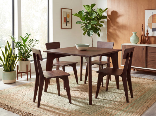 Dining room with bamboo table and chairs, plants, and a rug.