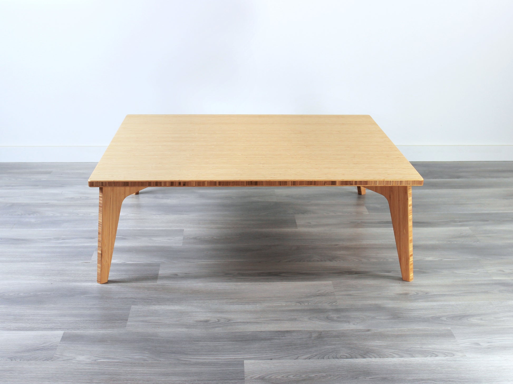 Large square floor table in bamboo with a natural color finish, featuring a Japandi style design, set on a grey floor with a white background. 

Square low table 
japanese furniture
japanese low table
low coffee table
low dining table
low table
mid century
minimalist
minimalist table
modern
chabudai
