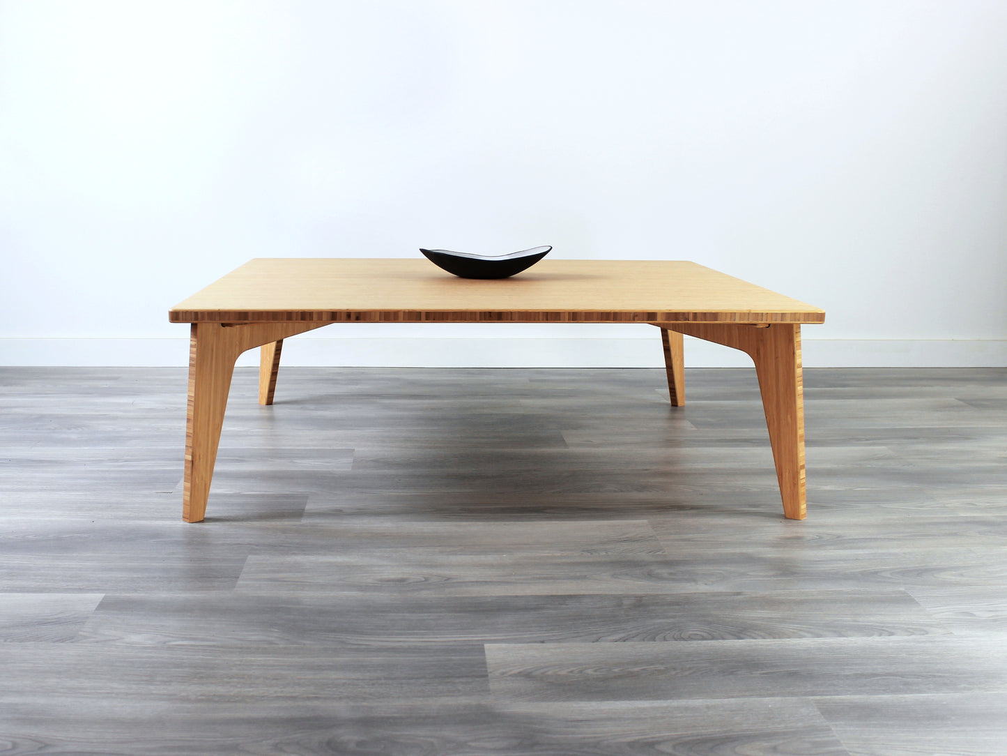 Large square floor table in bamboo with a chestnut color finish, featuring a Japandi style design, set on a grey floor with a white background. A small black pottery vessel sets on top. 

Square low table 
japanese furniture
japanese low table
low coffee table
low dining table
low table
mid century
minimalist
minimalist table
modern
chabudai

