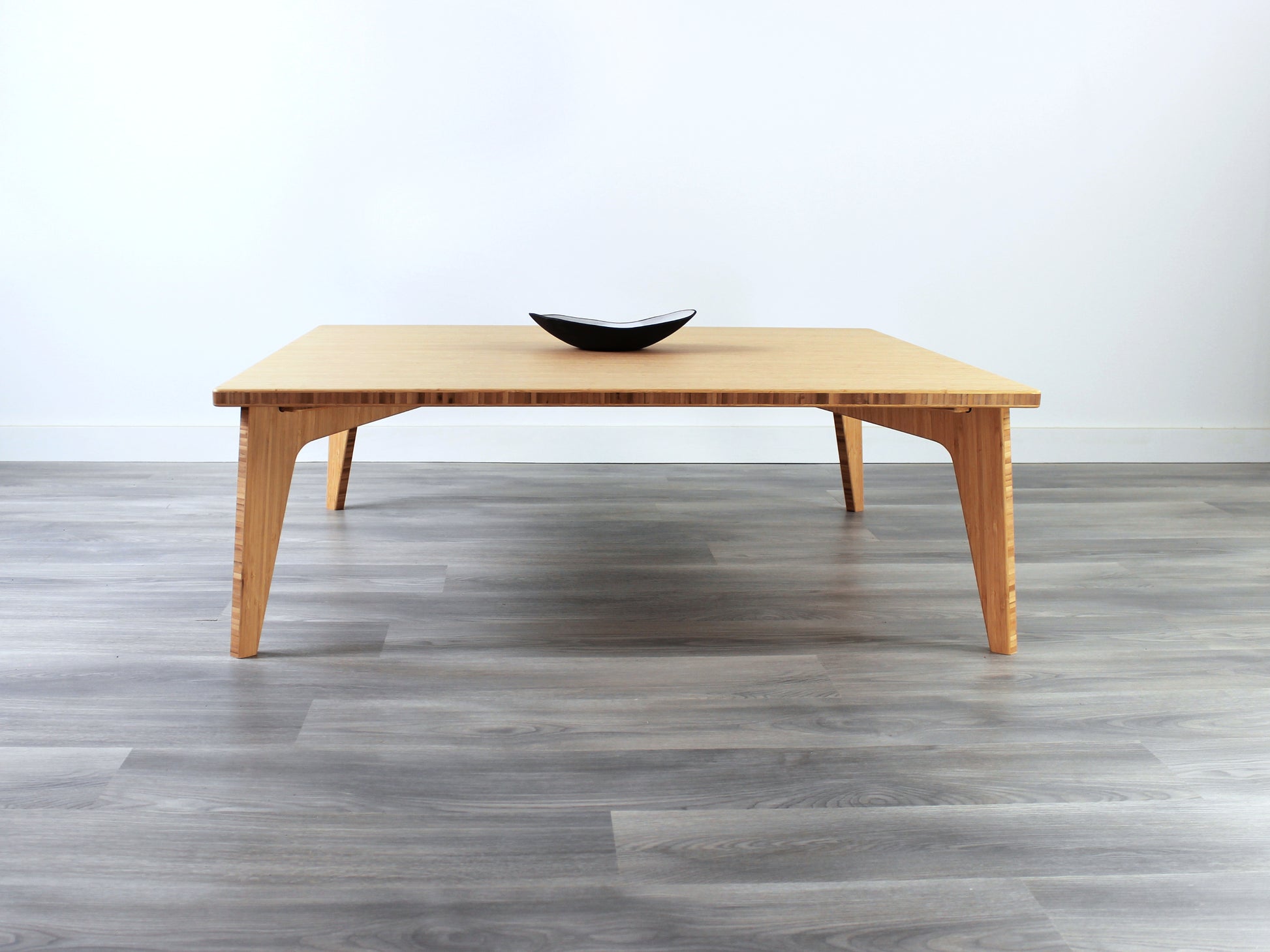 Large square floor table in bamboo with a chestnut color finish, featuring a Japandi style design, set on a grey floor with a white background. A small black pottery vessel sets on top. 

Square low table 
japanese furniture
japanese low table
low coffee table
low dining table
low table
mid century
minimalist
minimalist table
modern
chabudai
