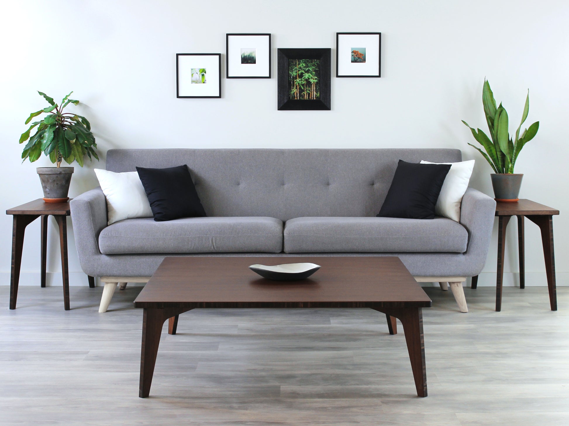 Large square floor table in bamboo with a walnut color finish, featuring a Japandi style design, set on a grey floor with a white background. Set in a living room area, a grey couch and side tables with houseplants. A small black pottery vessel is placed on the table top. 


Square low table 
japanese furniture
japanese low table
low coffee table
low dining table
low table
mid century
minimalist
minimalist table
modern
chabudai